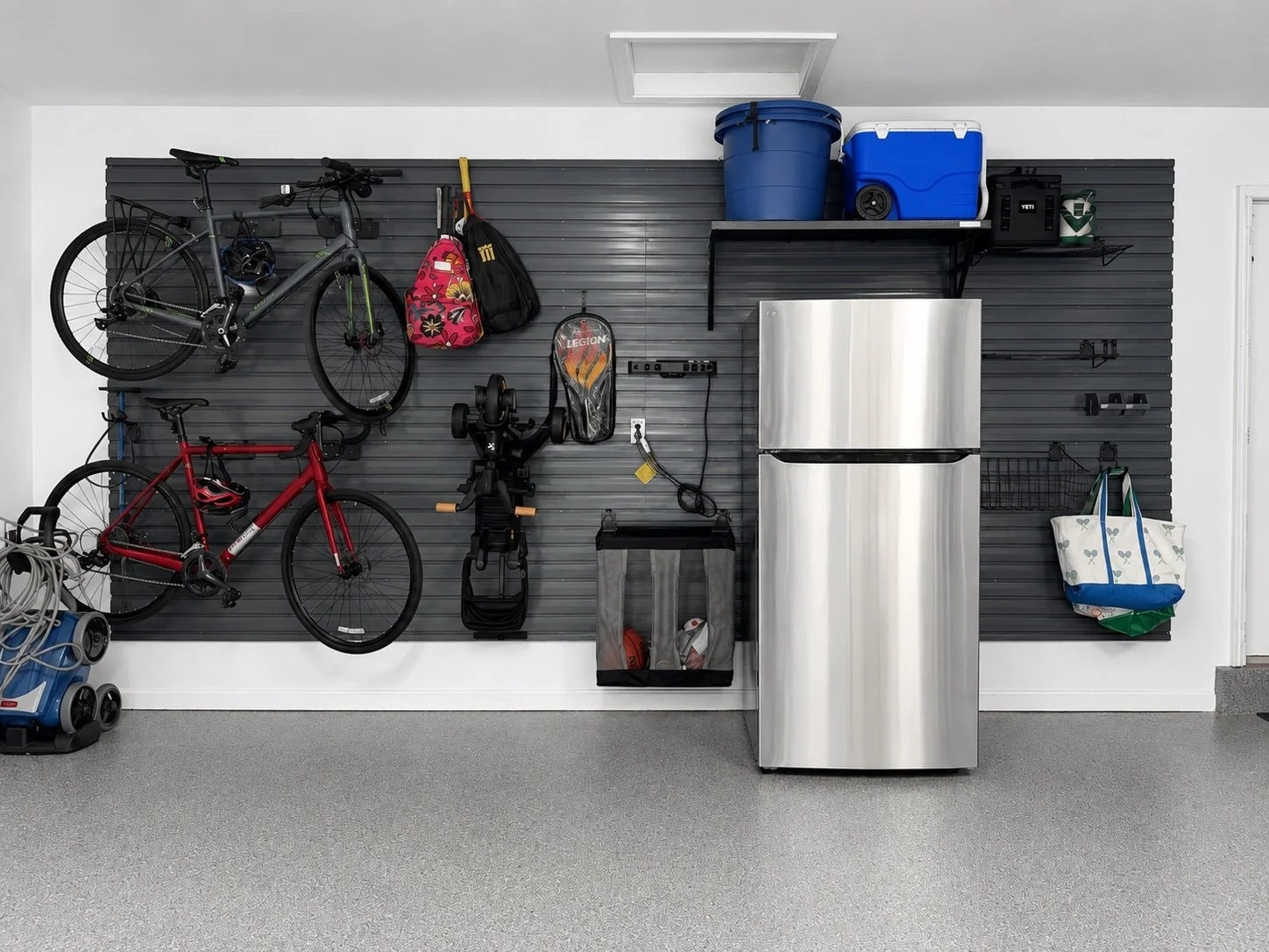 A clean garage with slat walls installed by Sort It Out.