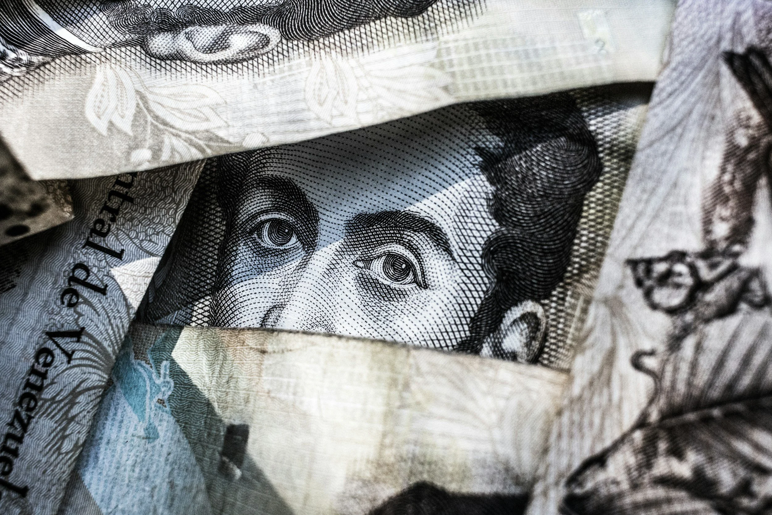 Close-up of crumpled paper currency, prominently showing the face of a person on a banknote.
