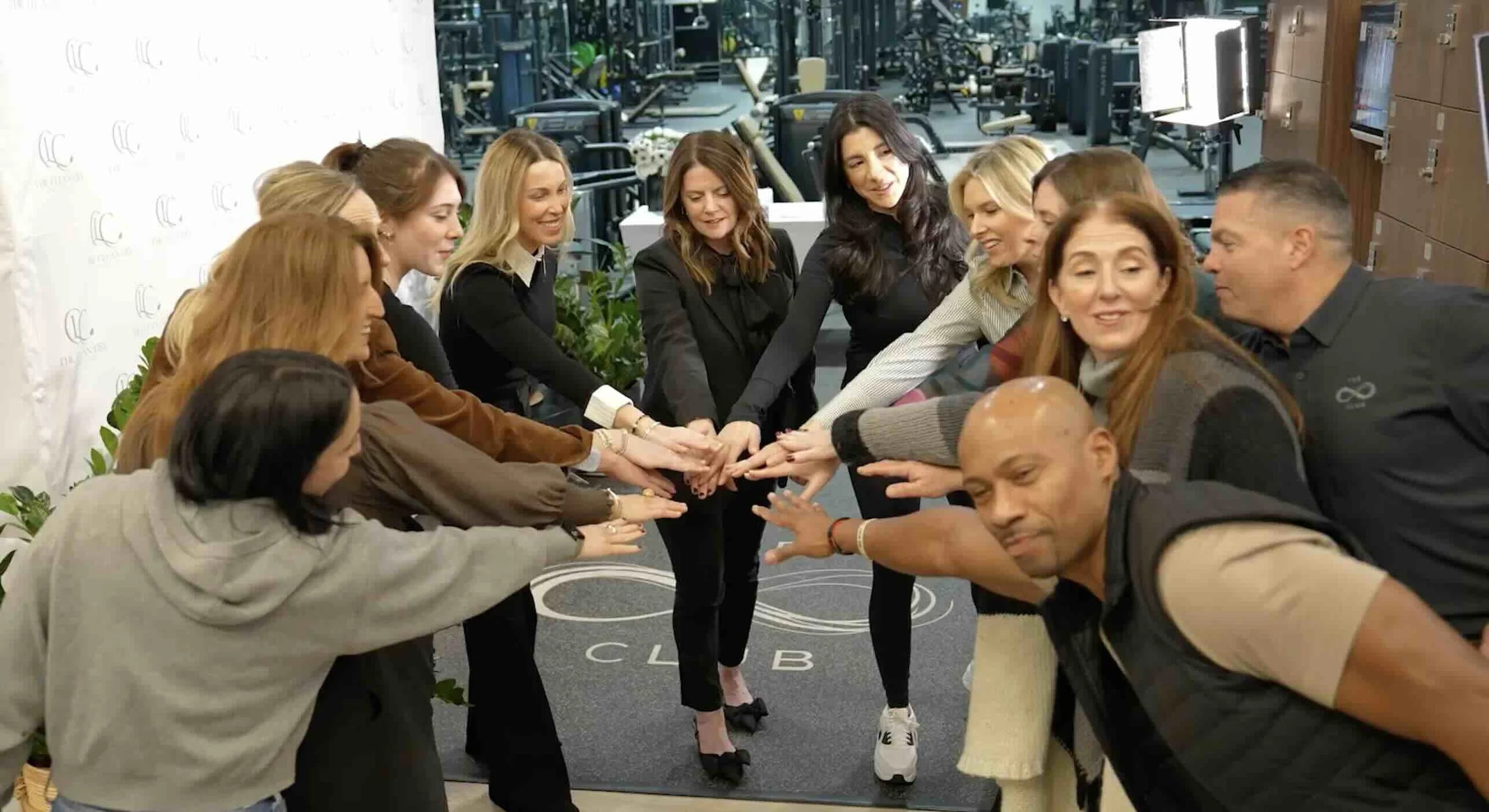 New Jersey corporate team joining hands to start a company event, captured by Nova House Productions.