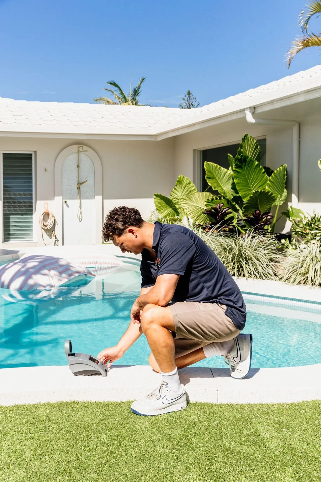 Ashmore Pools technician checking pool equipment at a Gold Coast home