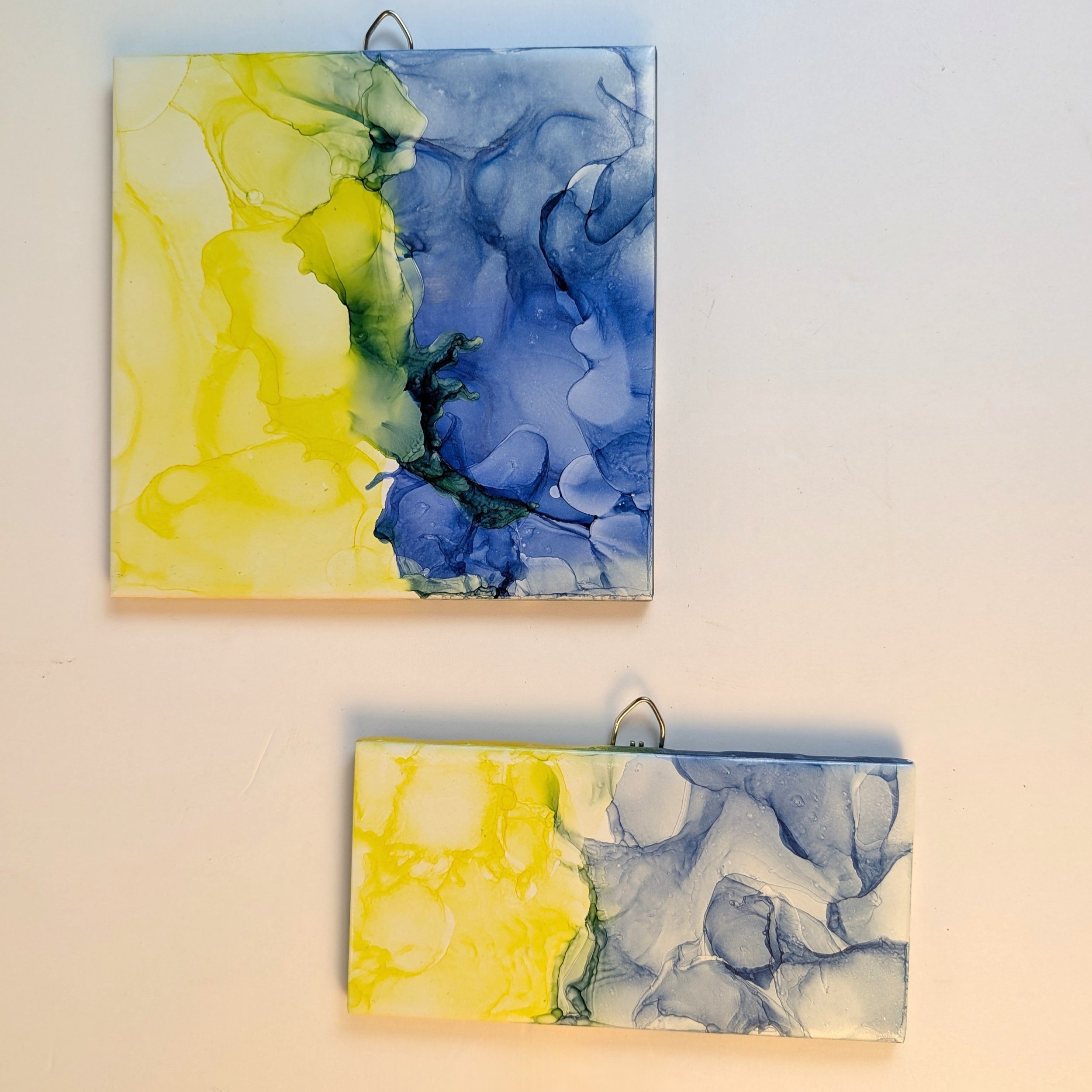Yellow and Blue alcohol ink on a 6 x 6-inch ceramic tile and a 3 x 6-inch ceramic tile that can be hung on a wall