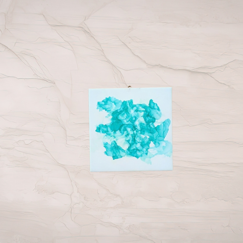 Turquoise alcohol ink on ceramic tile