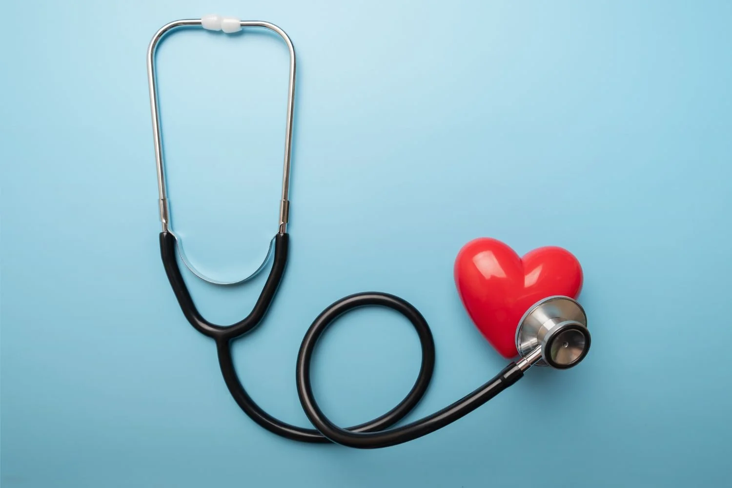 A stethoscope on a small heart shape