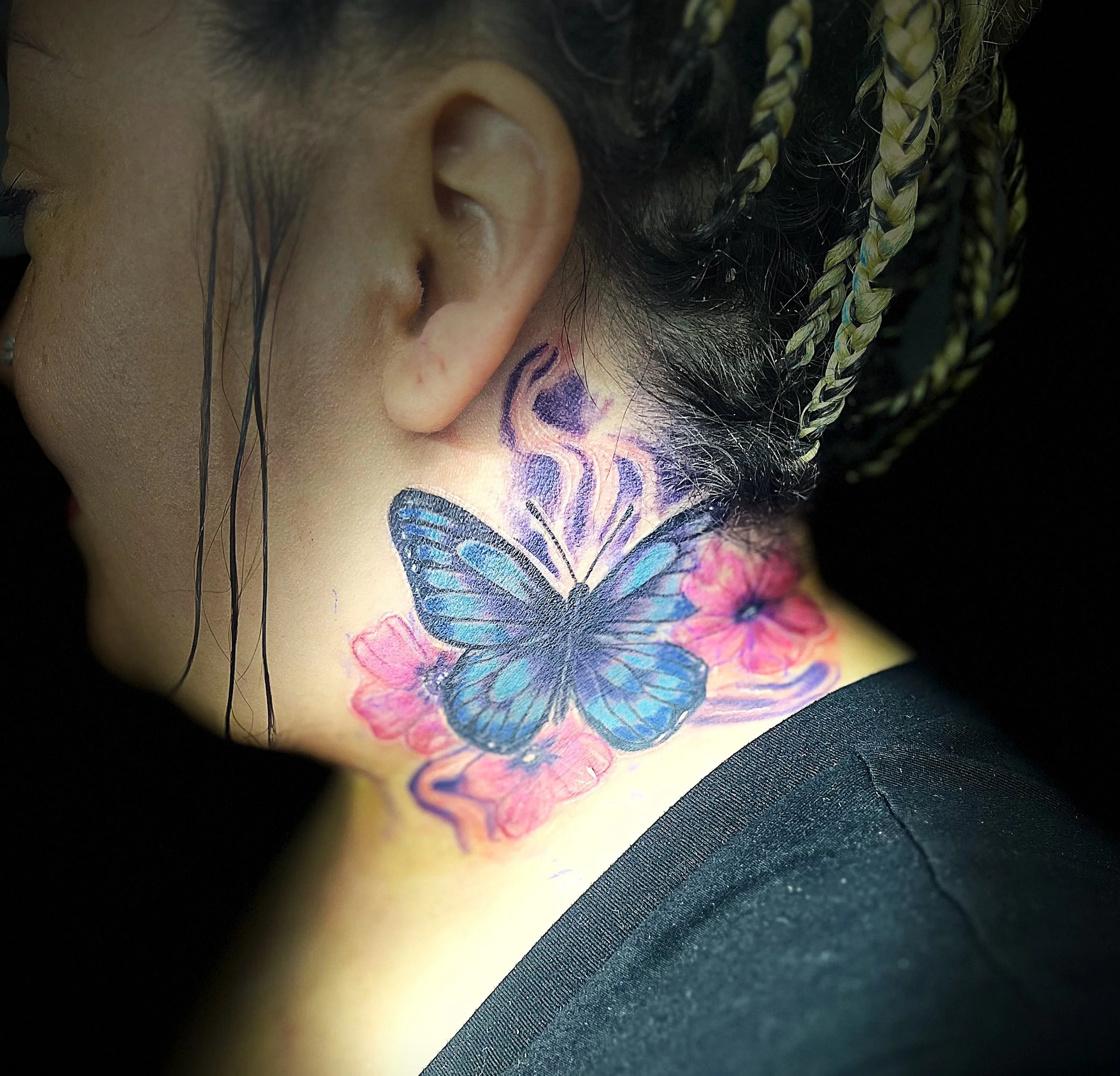 Neck tattoo of a butterfly with flowers