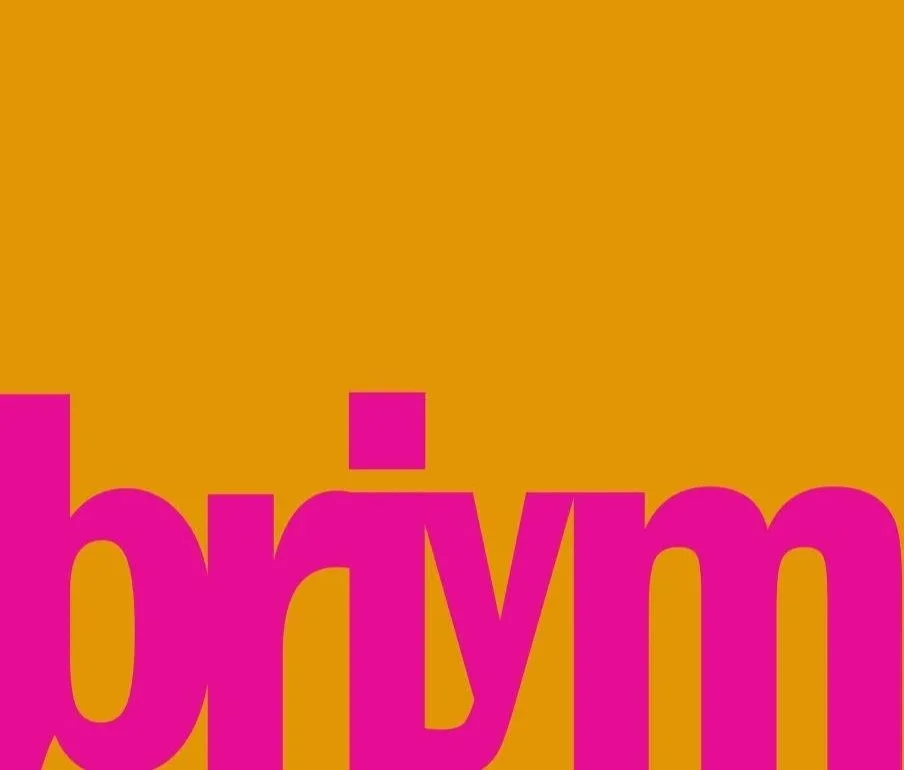 Close-up of colorful text with pink letters on an orange background.