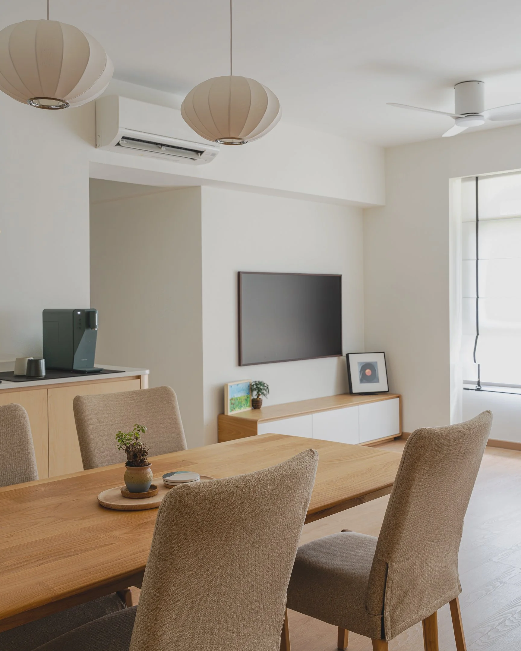 dining room view into living room of a 5 room hdb in Tengah designed by couple abode