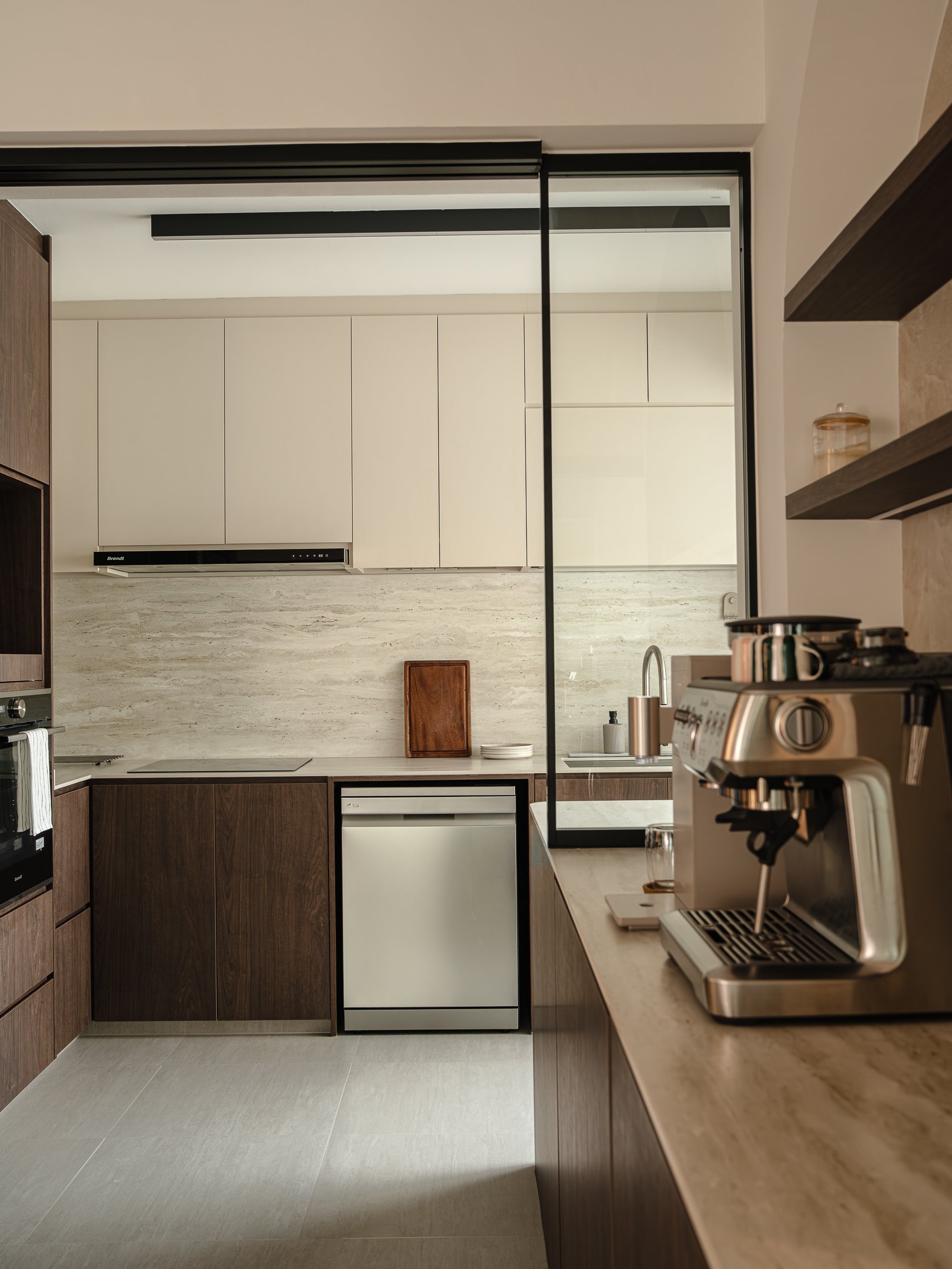 Modern Singapore BTO kitchen with dark wood cabinetry, glass sliding partition, concealed storage, and contemporary minimalist interior design.