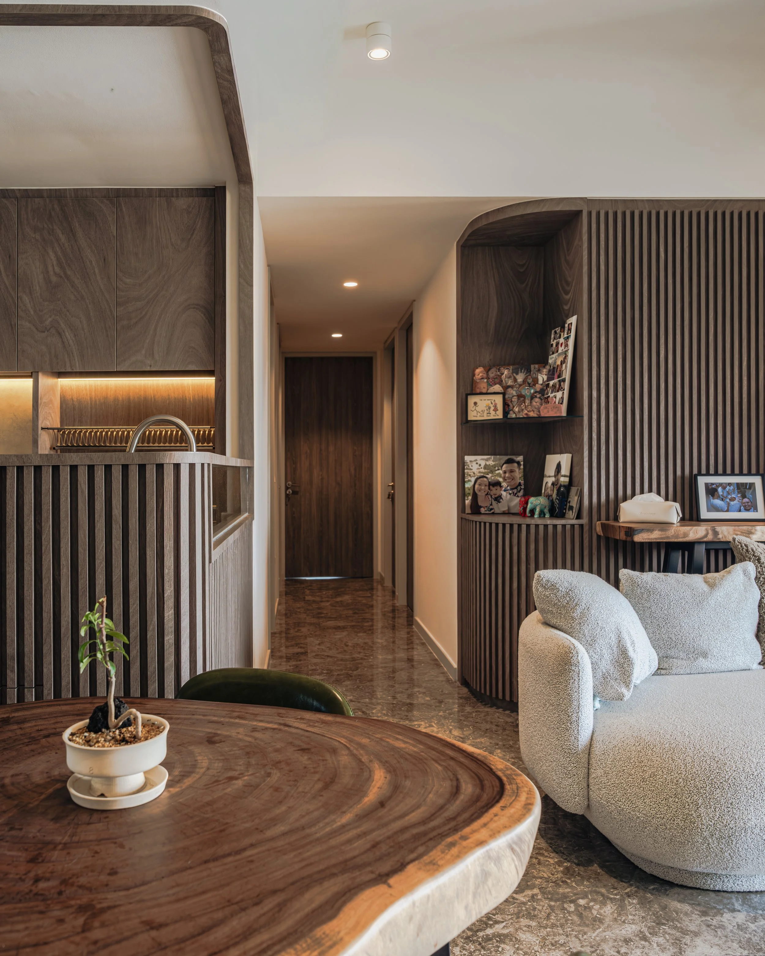 Architectural detail of curved wood carpentry, a hallmark of 2026 Warm Minimalism, highlighting soft edges and natural materials in Singapore home renovation.