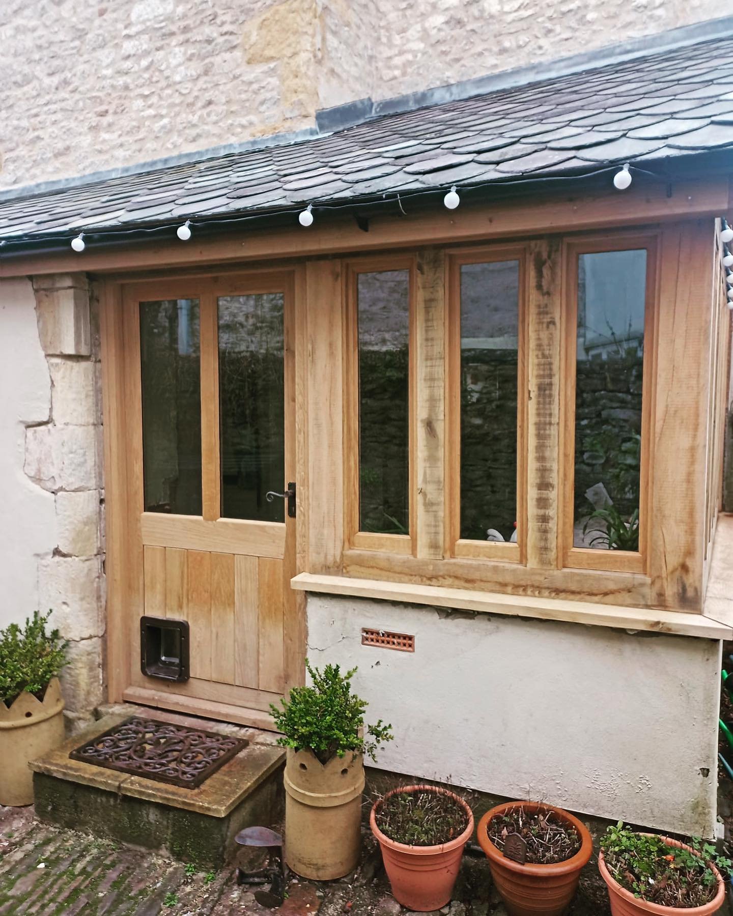 Oak porch, after a bit of weathering. #oak #joinery #bespokewoodwork #customwoodwork #porch #carpentry