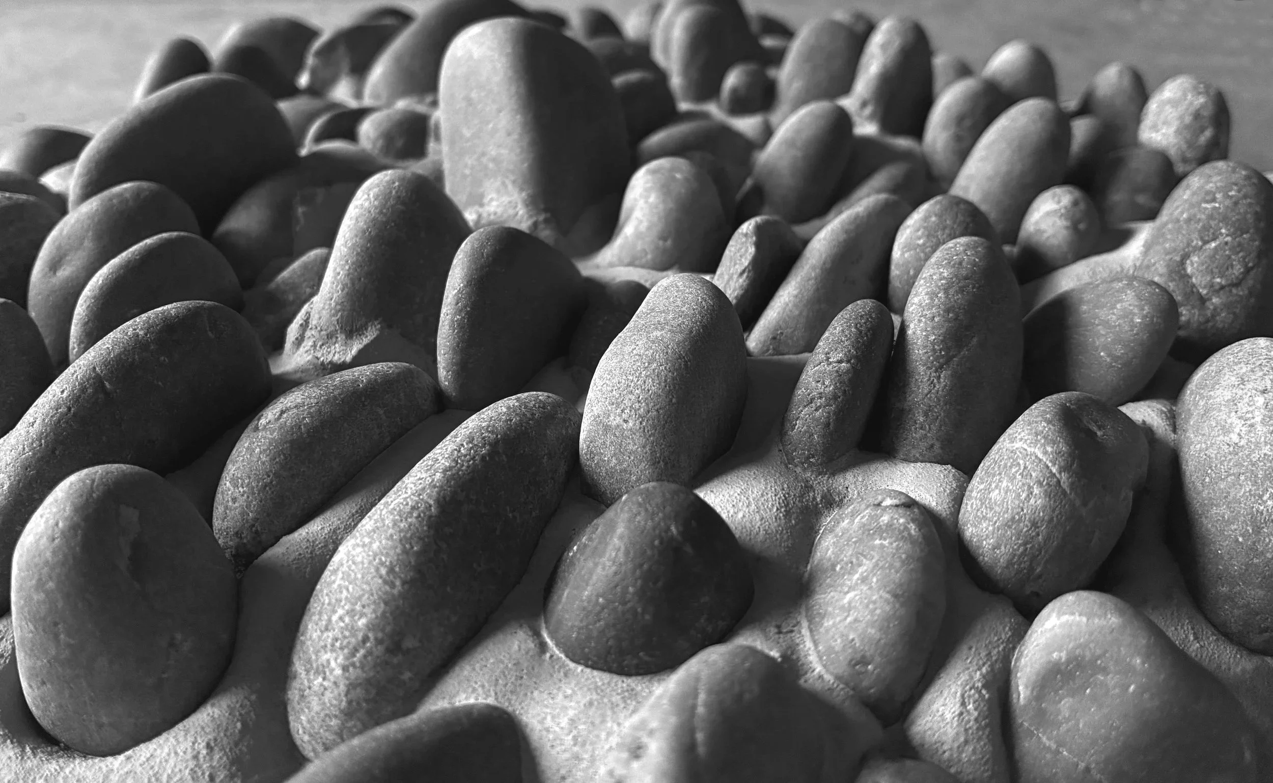 Pebbles set on edge in mosaic