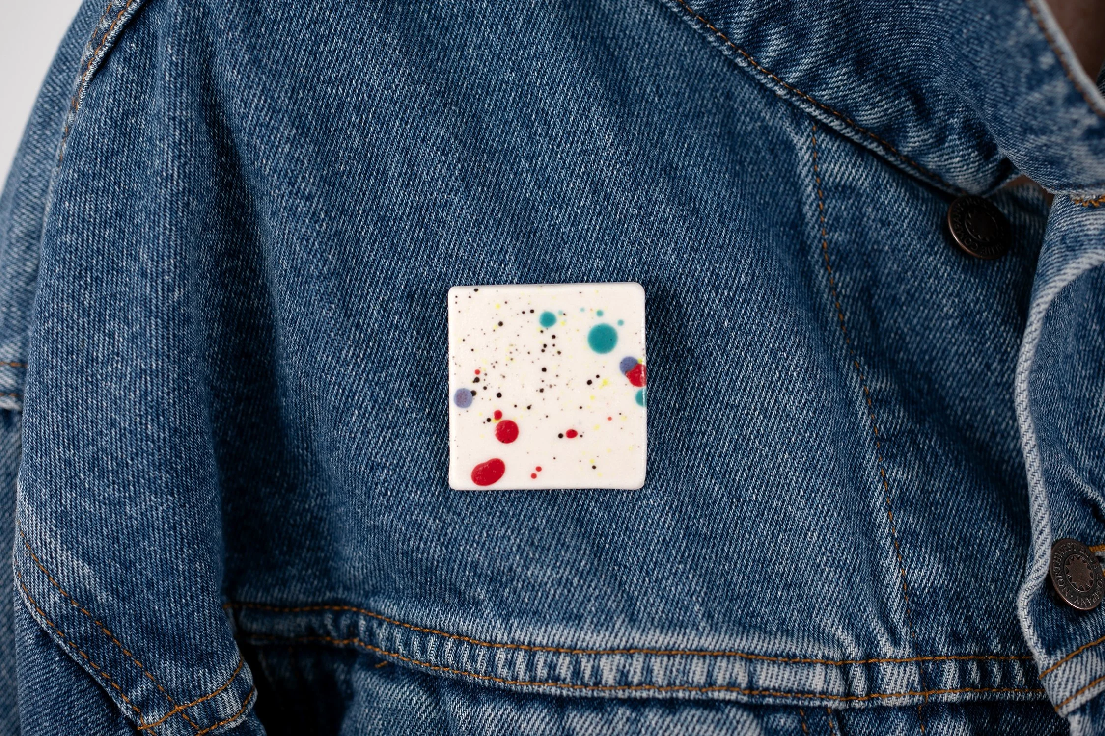 porcelain pin, with multicolored splatter paint