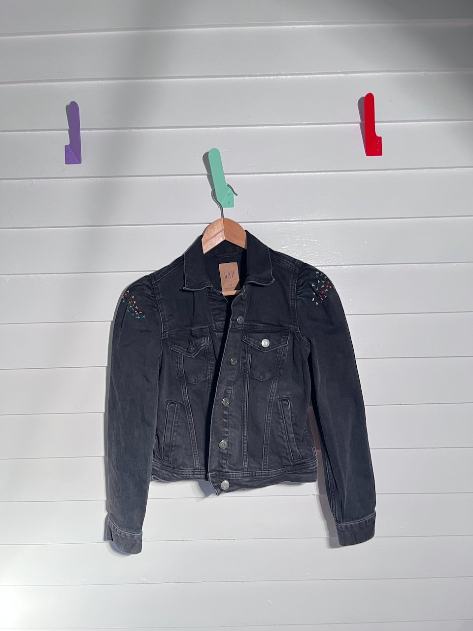 black denim jacket with delicate handwork on puffed sleeves