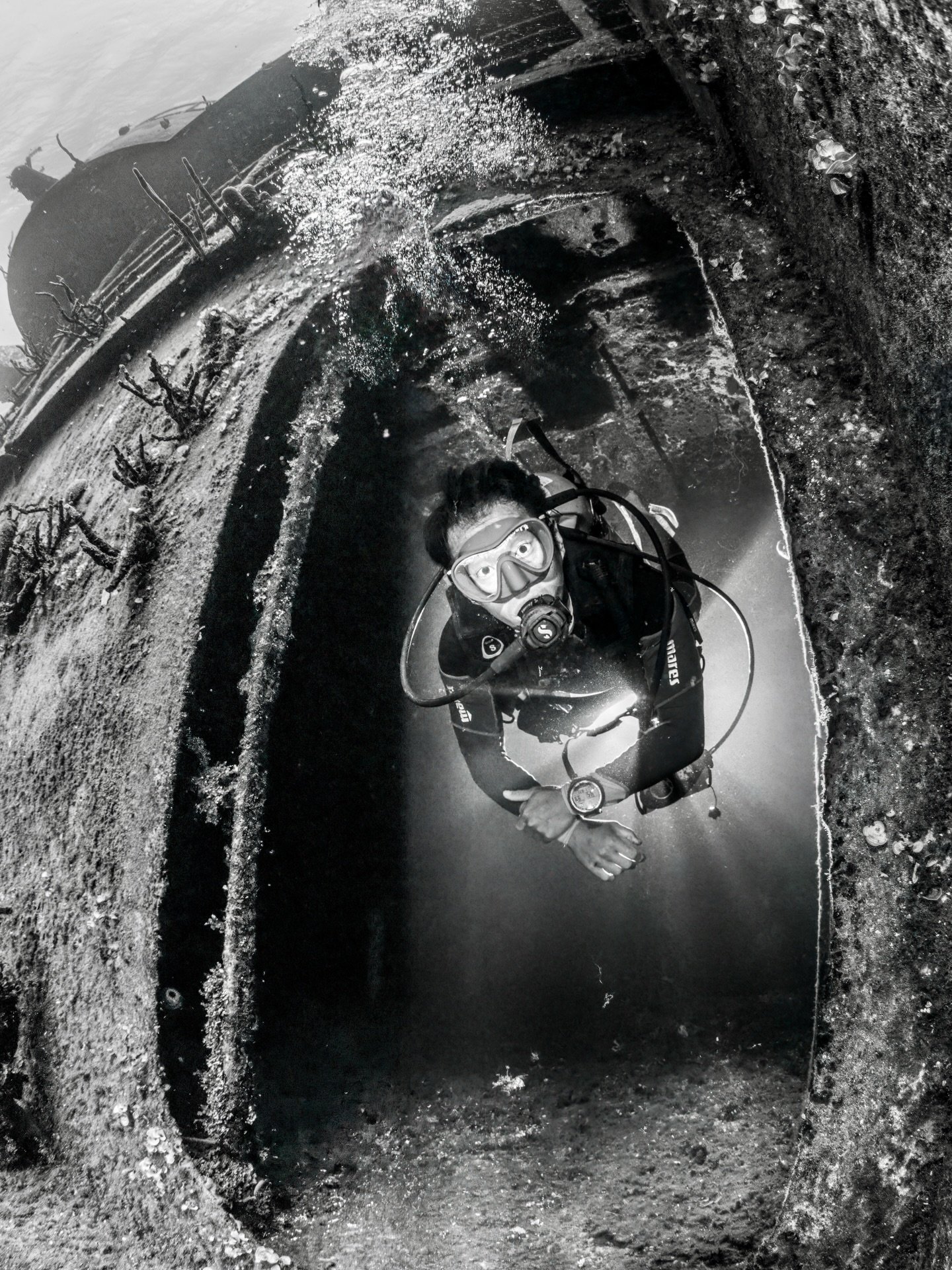 &ldquo;Fractured Light.&rdquo; 

Framed by the skeletal structure of the sunken ship, our model diver hovers within a narrow entryway on the Kittiwake where light and shadow collide. This image was a result of experimenting with backlighting and off 
