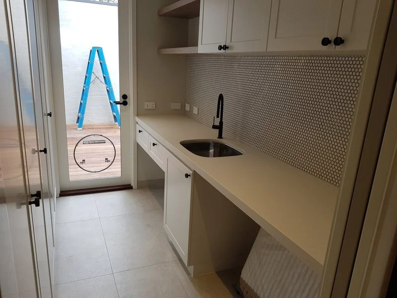 white clean cabinetry in laundry.jpeg