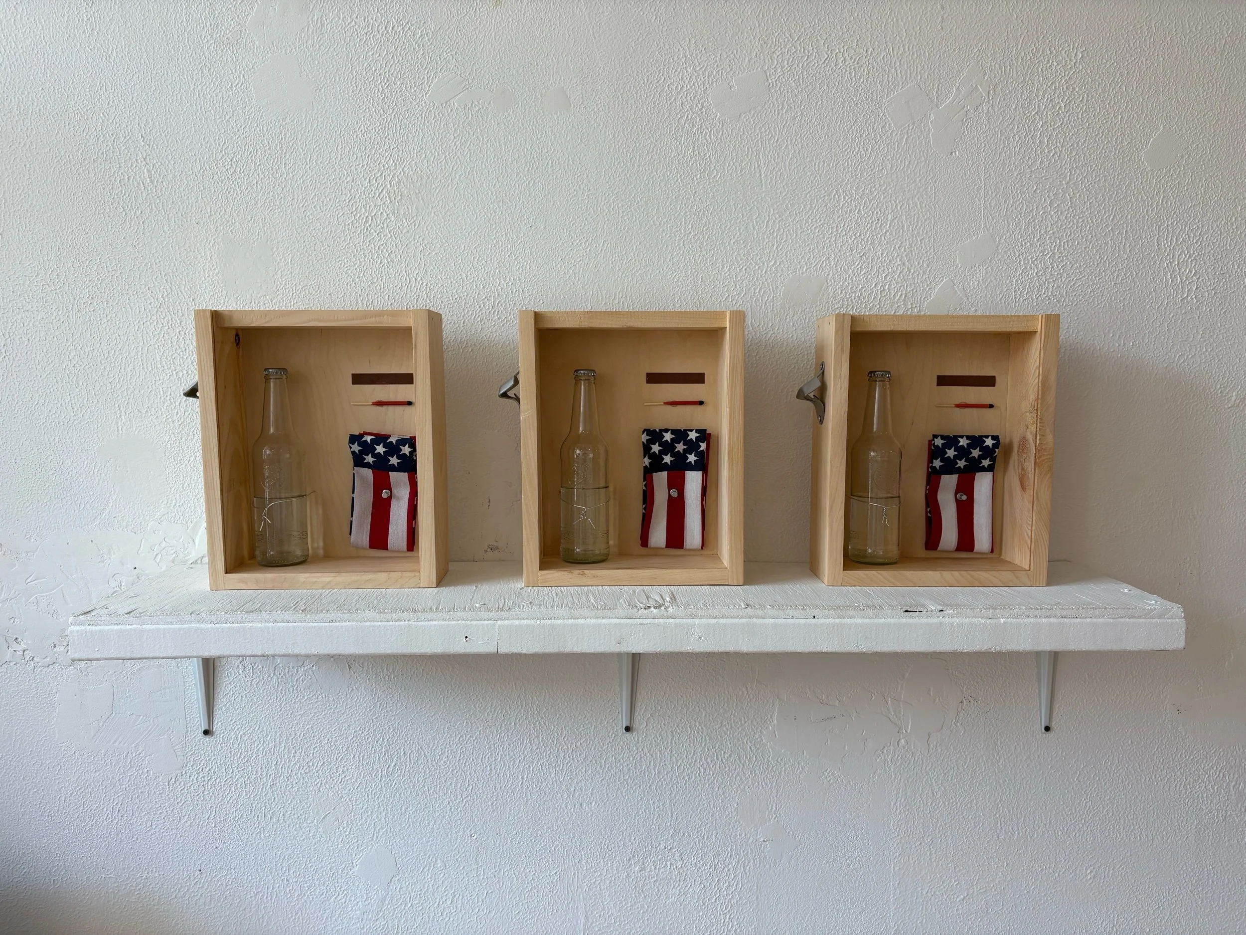 Joel Olzak,First Amendment Kit, Wood, Distilled Water, Glass, Steel, Aluminum, Matchstick, Flag, Sandpaper, Wax  13x9x4”, 2026, $400/Each