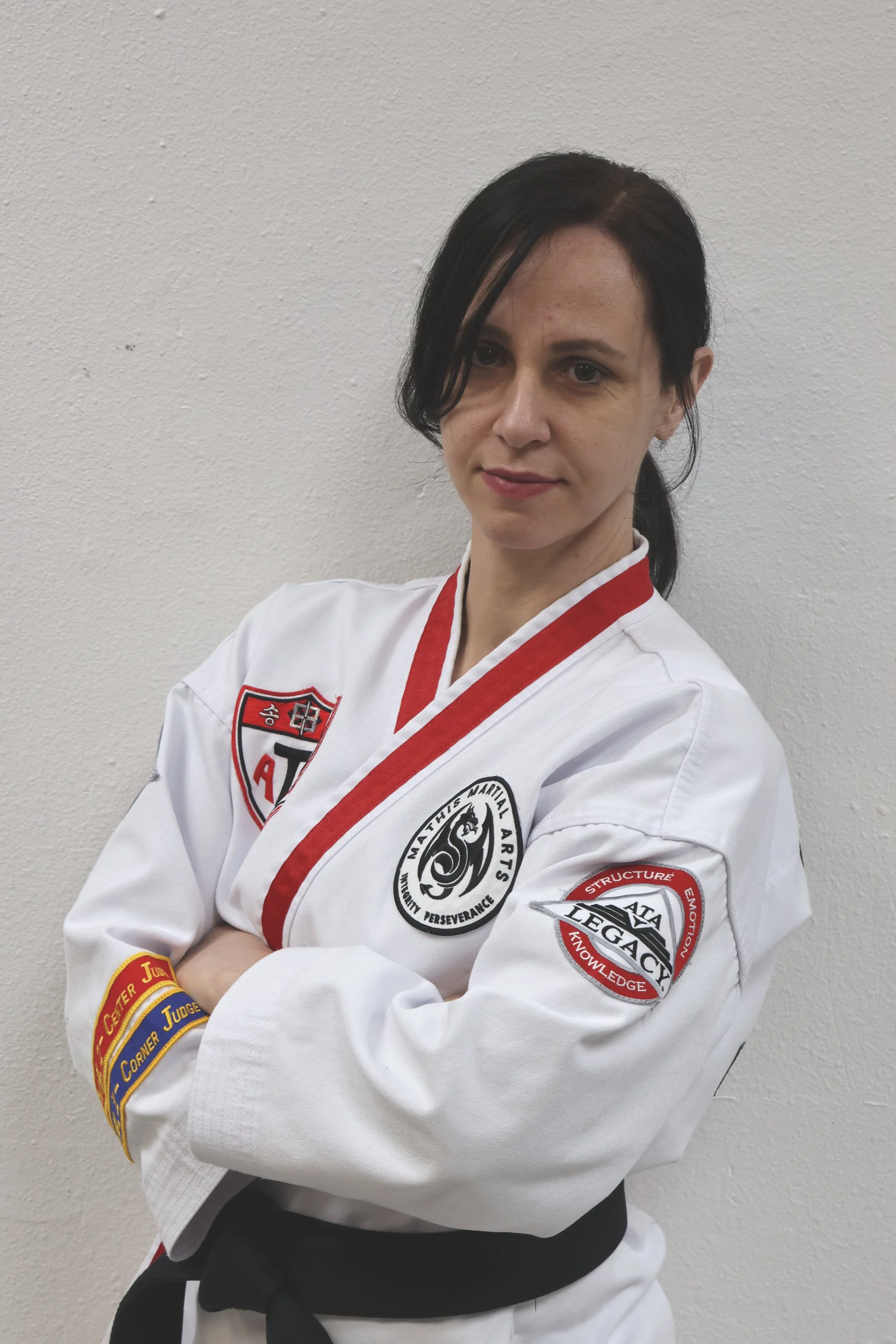 ATAV Legacy logo with a martial arts figure in black on a yellow and black background.