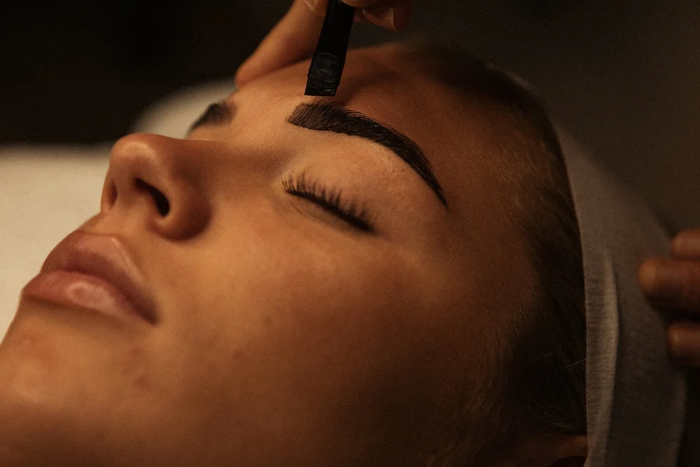 Brow colour applied with a brush during an eyebrow treatment