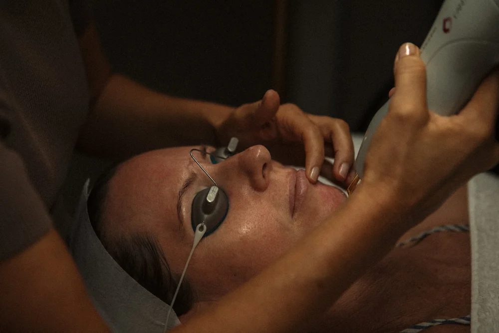 Client wearing protective eye shields during laser treatment