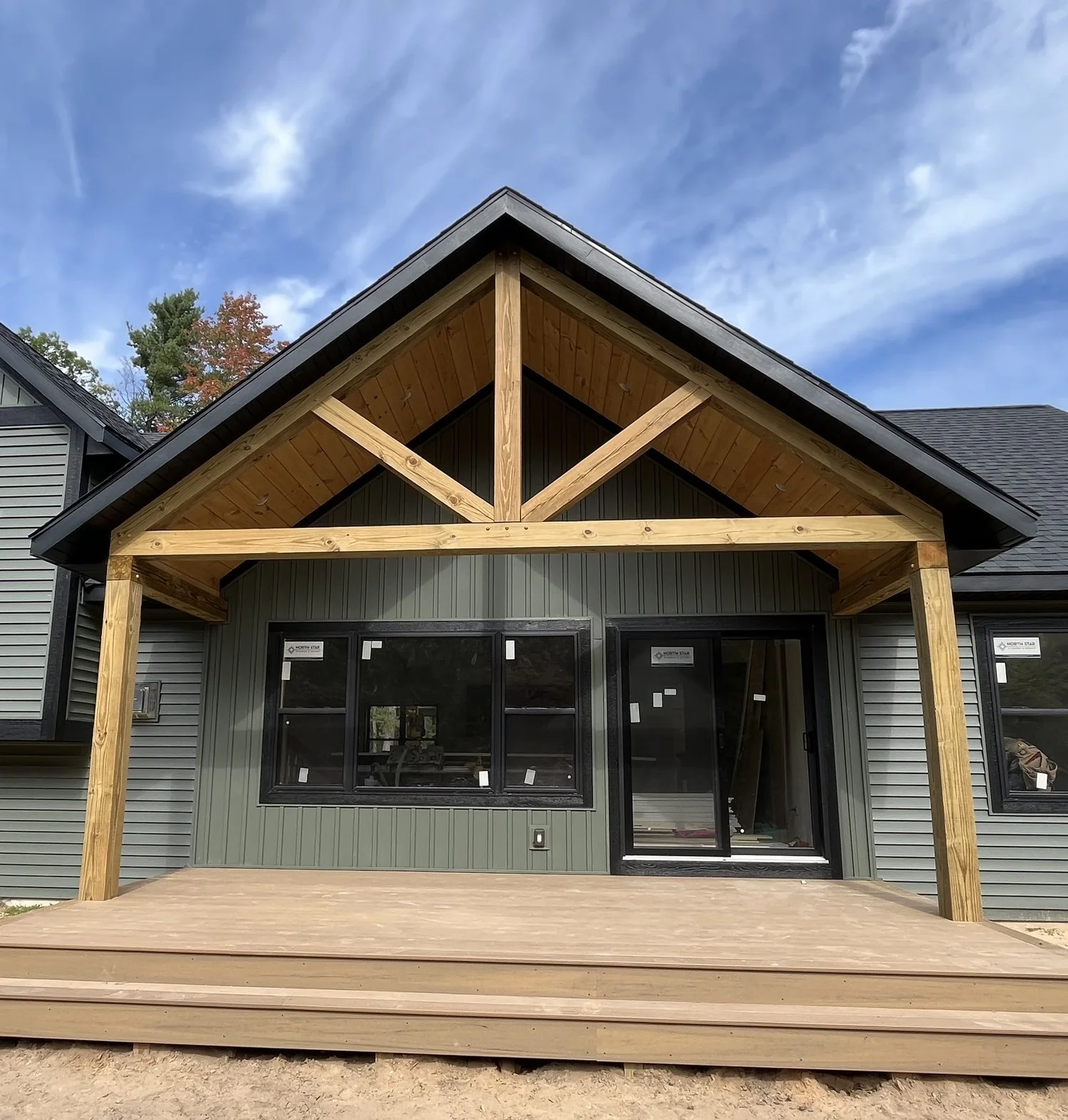 Modern house exterior with wooden porch and gable roof