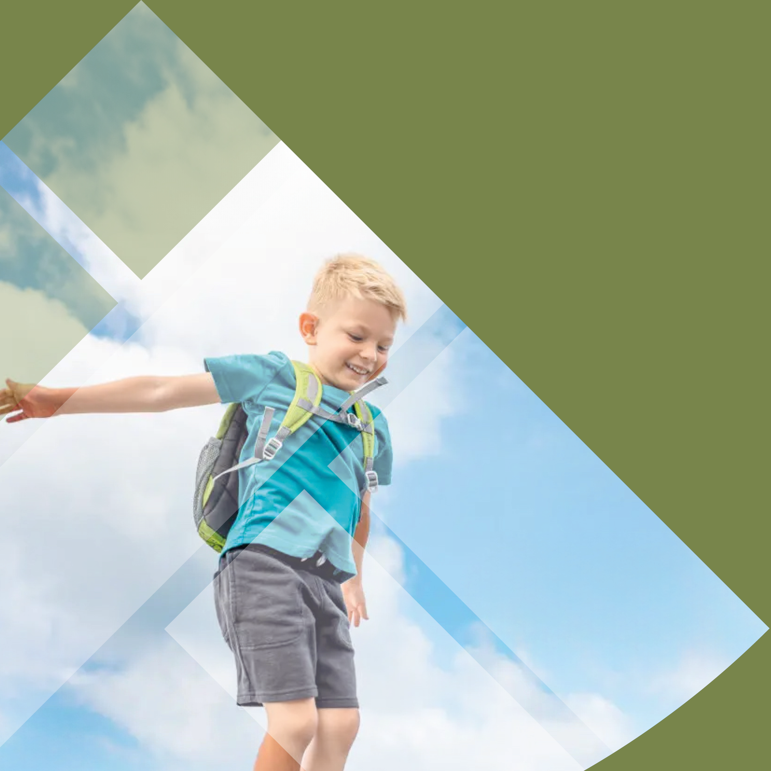 A young boy with a backpack jumping outdoors under a blue sky with clouds.