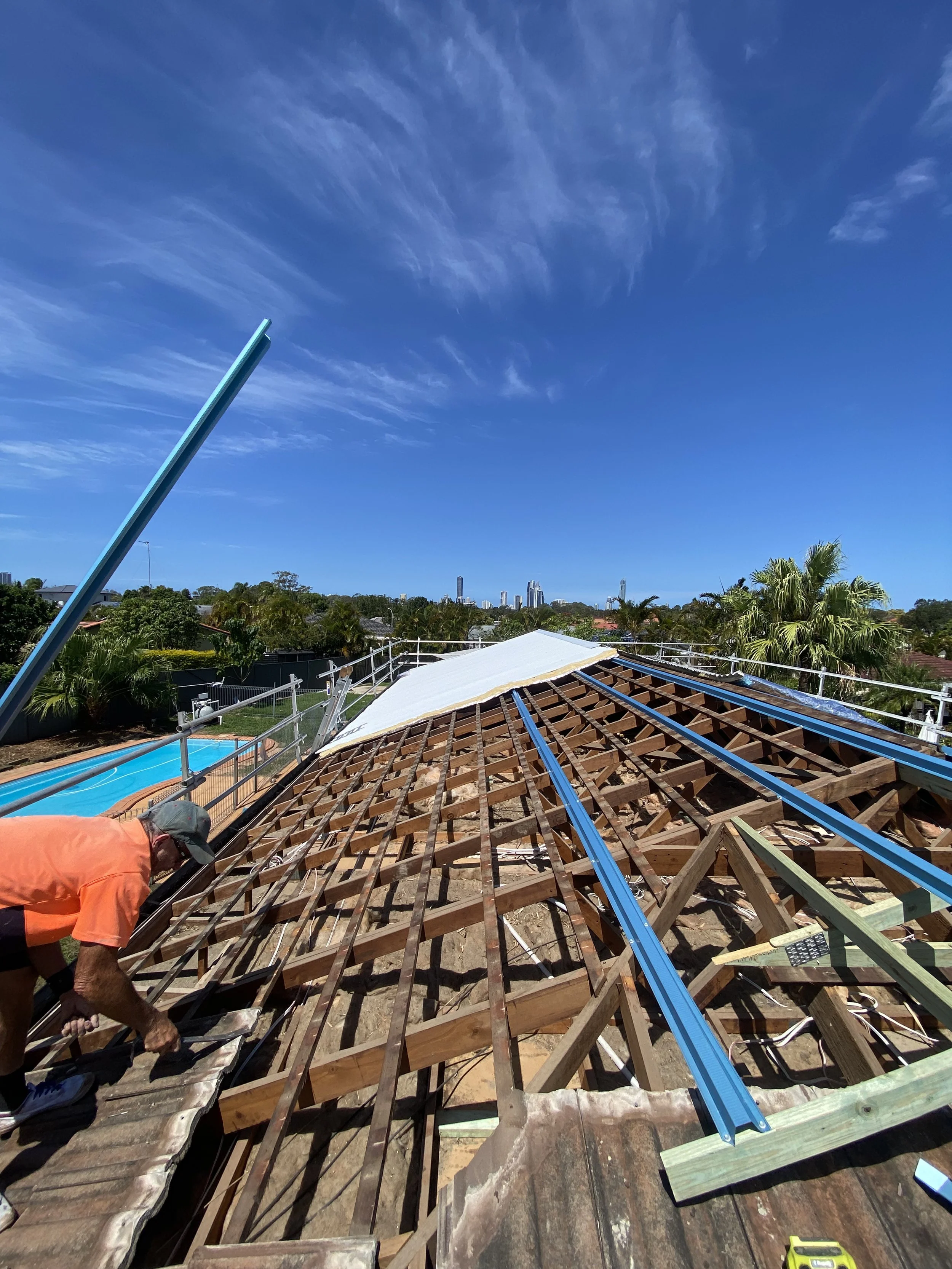 Roof under construction by subcontractor with Surfers Paradise, Gold Coast skyline