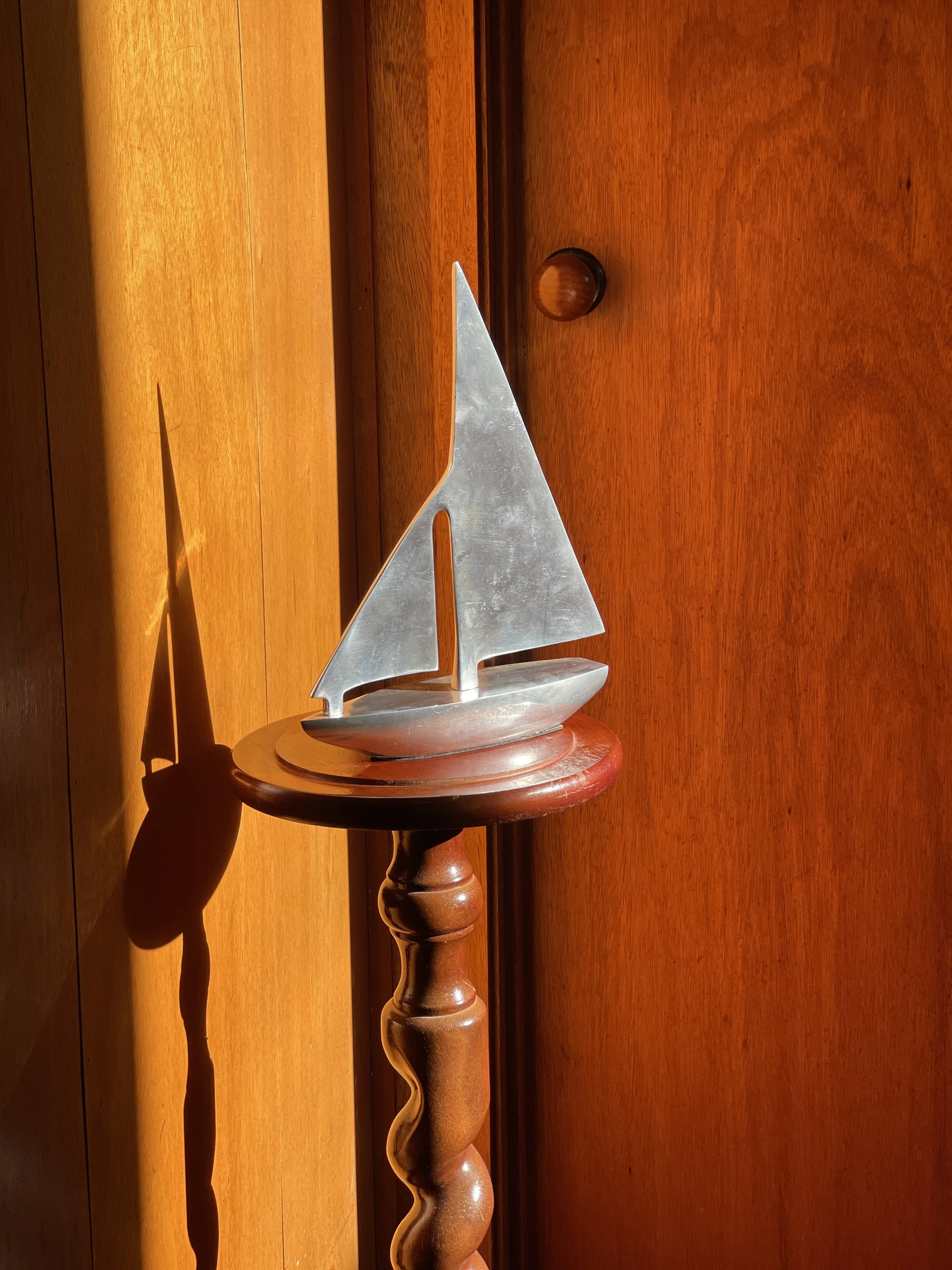 brushed metal sailboat sculpture