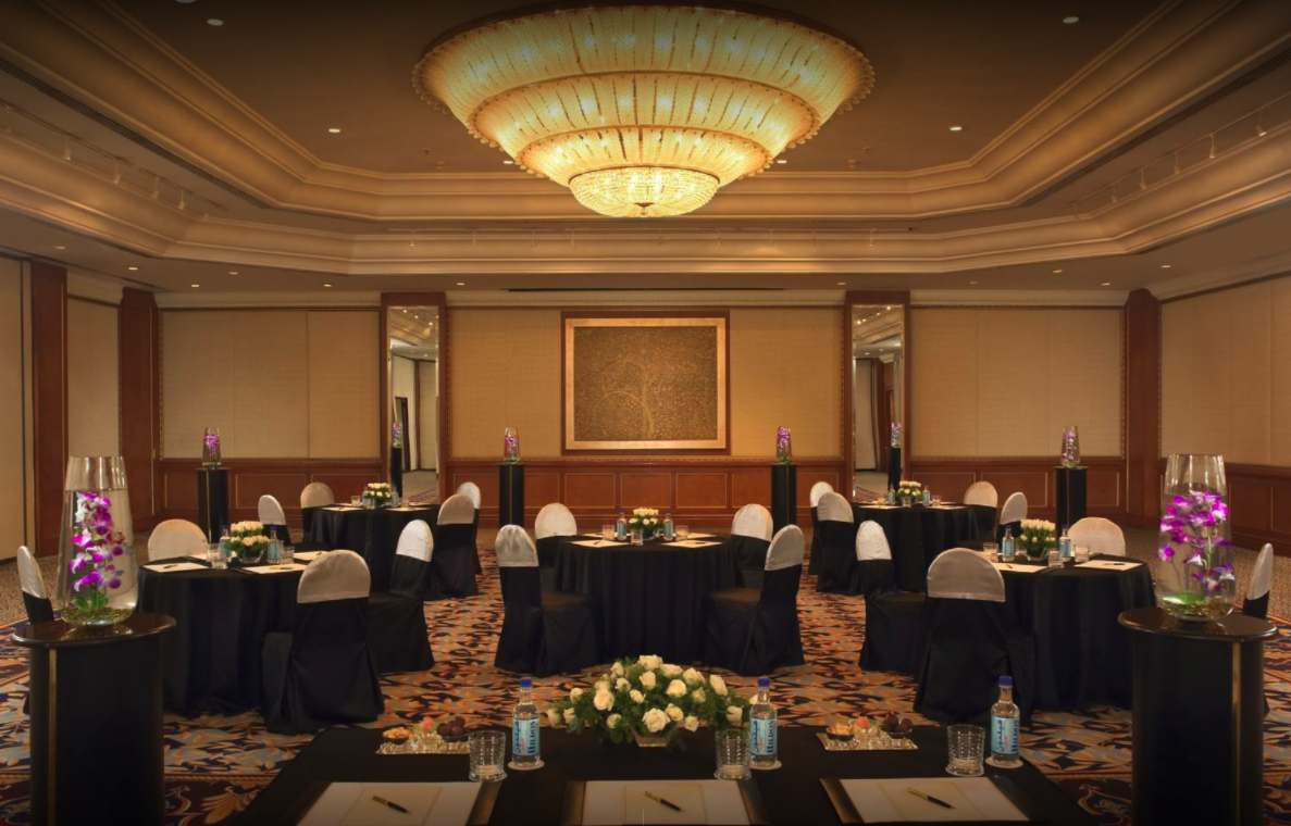 Ballroom with a crystal ceiling light at The Leela Mumbai