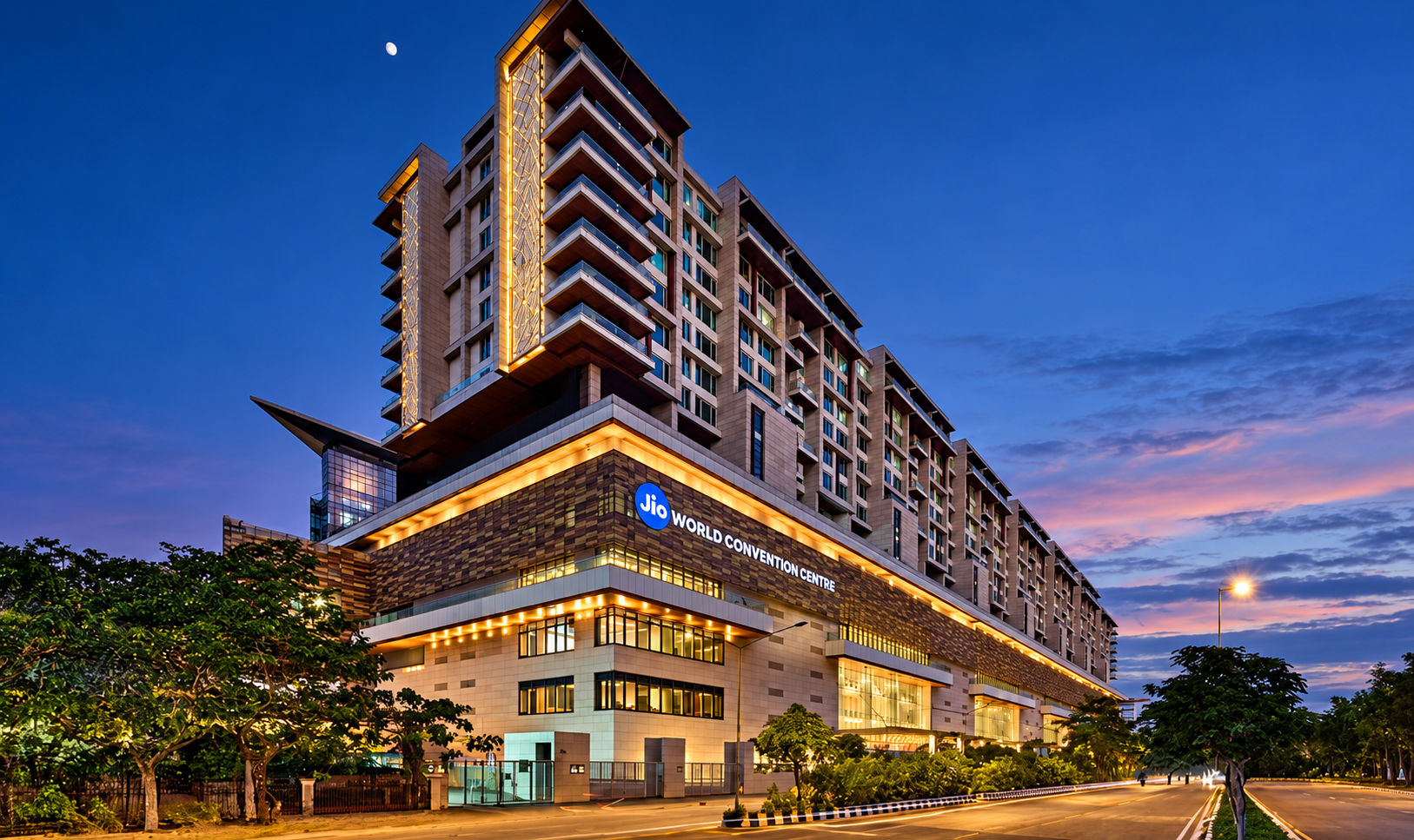 Jio World Convention Centre and hotel tower at dusk