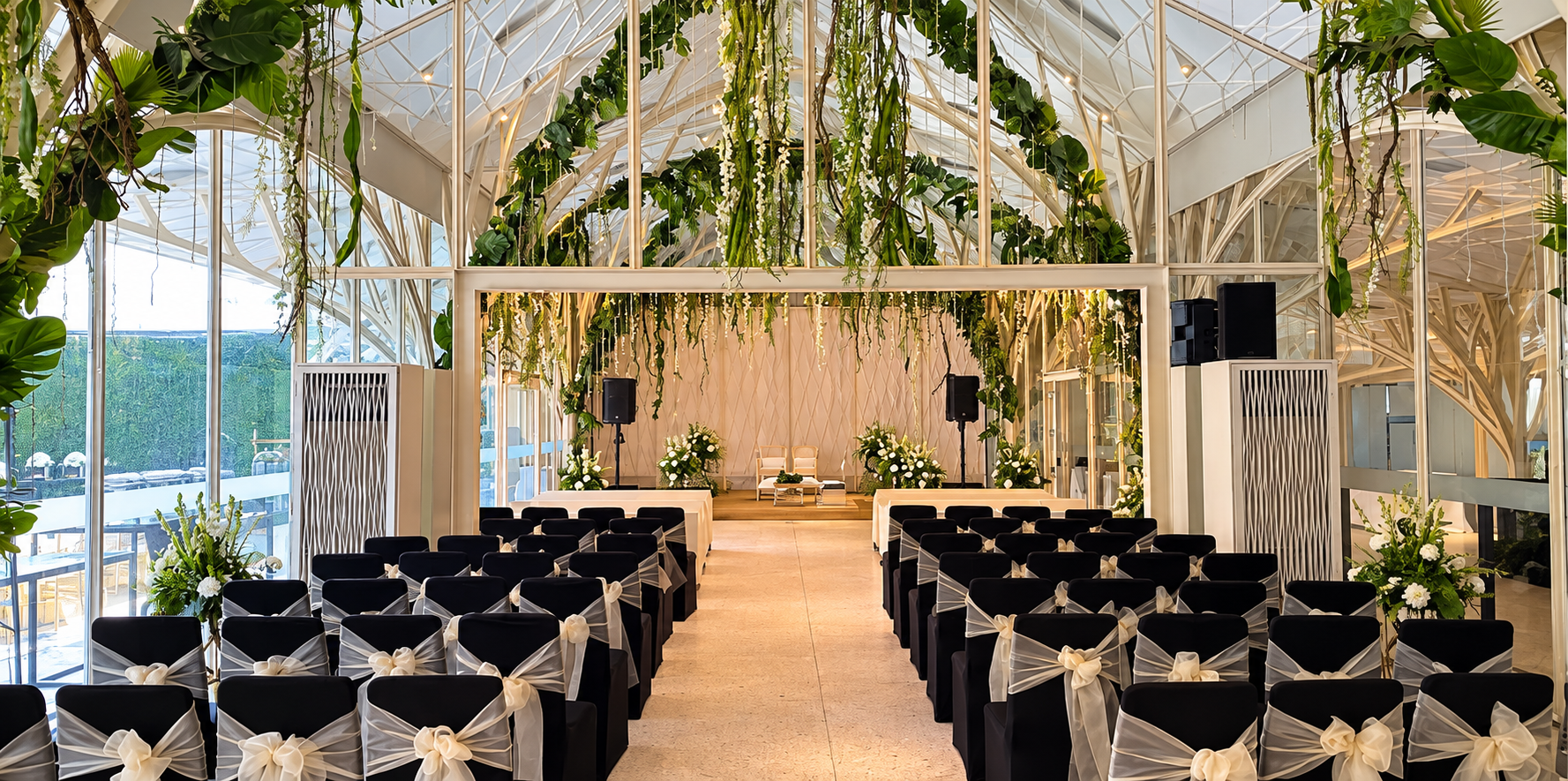 Glasshouse ceremony seating with hanging greenery at Tote on the Turf