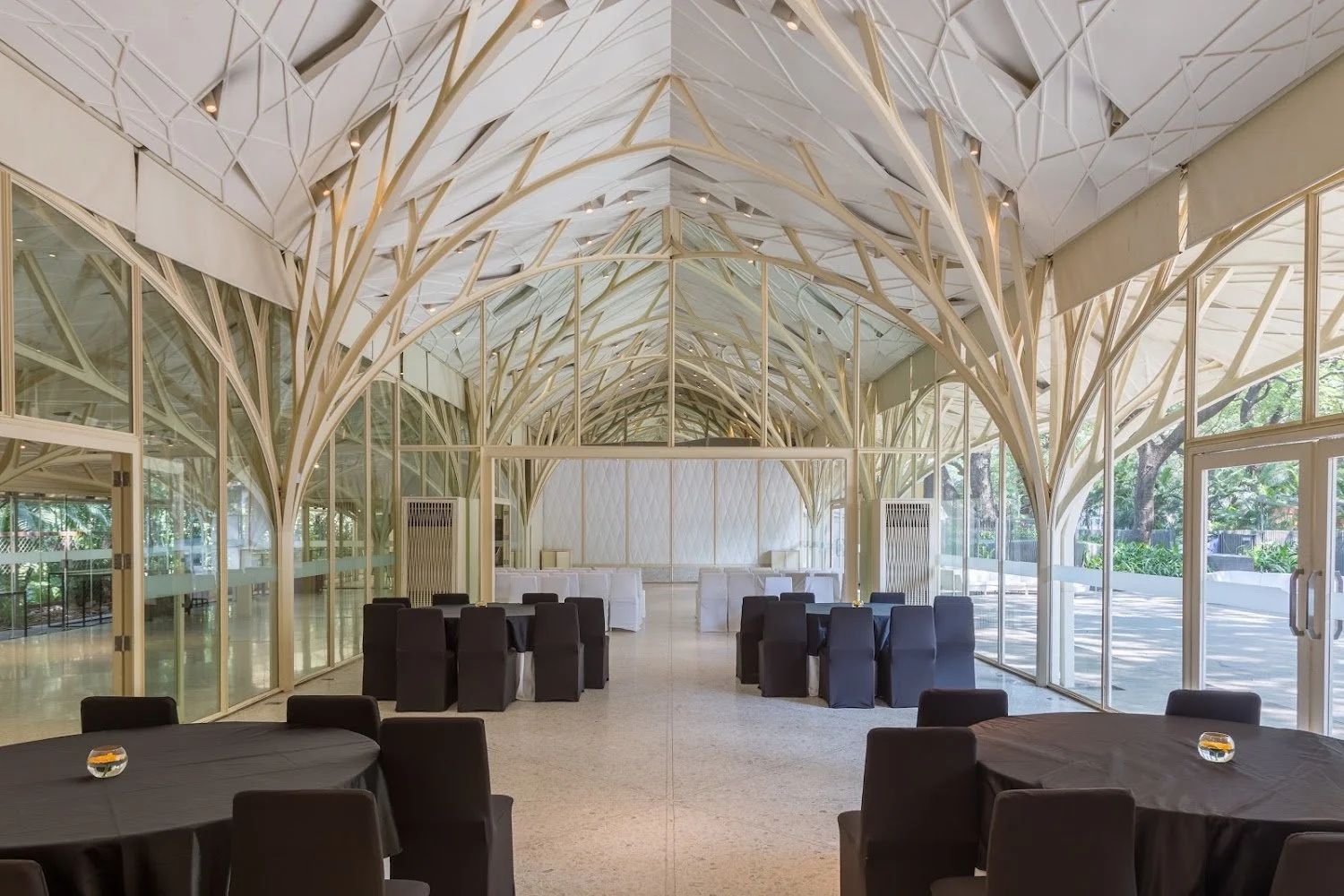 Glass pavilion with branching white columns at Tote on the Turf