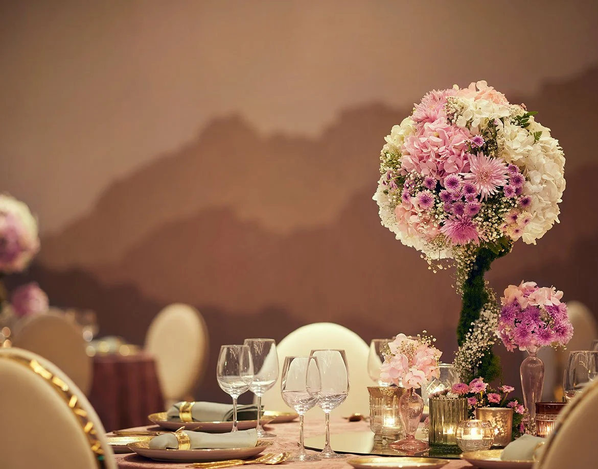 Pink floral centrepiece on a dinner table at JW Marriott Juhu