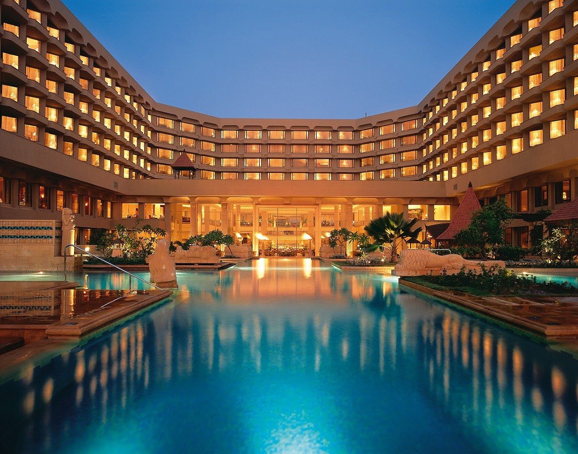 Pool and hotel wings lit at dusk at JW Marriott Mumbai Juhu