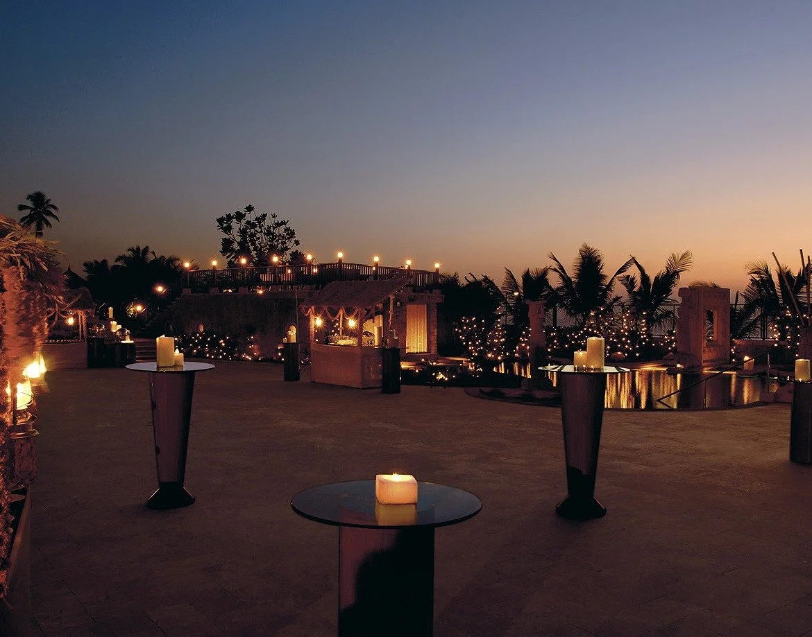 Seaside terrace cocktail setup at dusk at JW Marriott Juhu