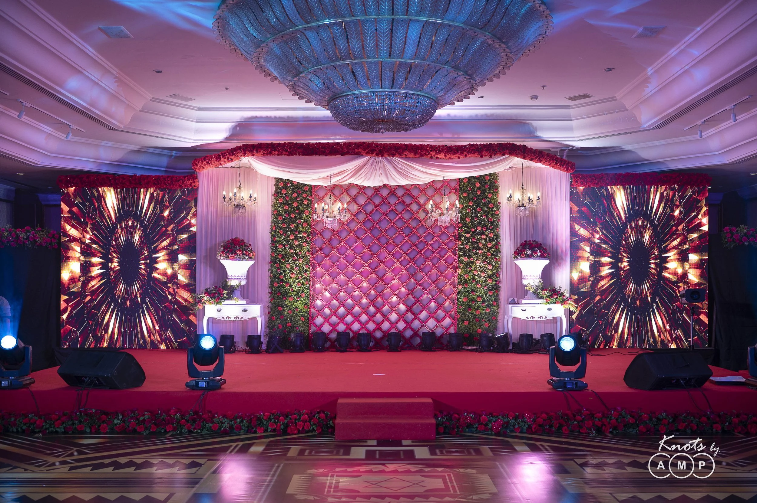 Pink-lit reception stage with LED walls at The Leela Mumbai