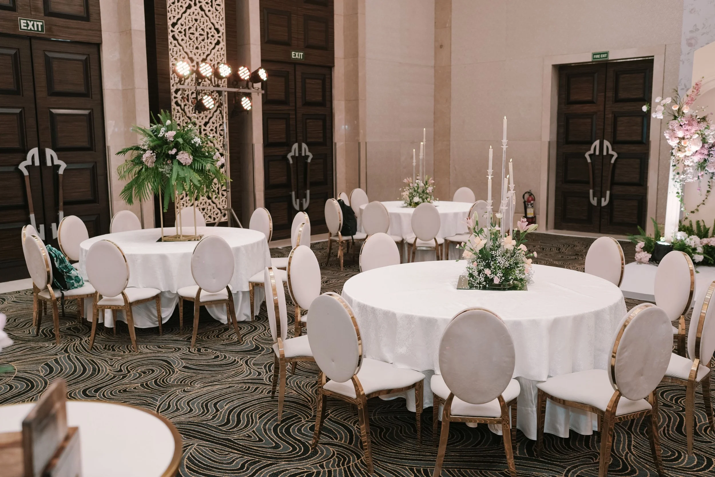 Round tables with white chairs at The St. Regis Mumbai