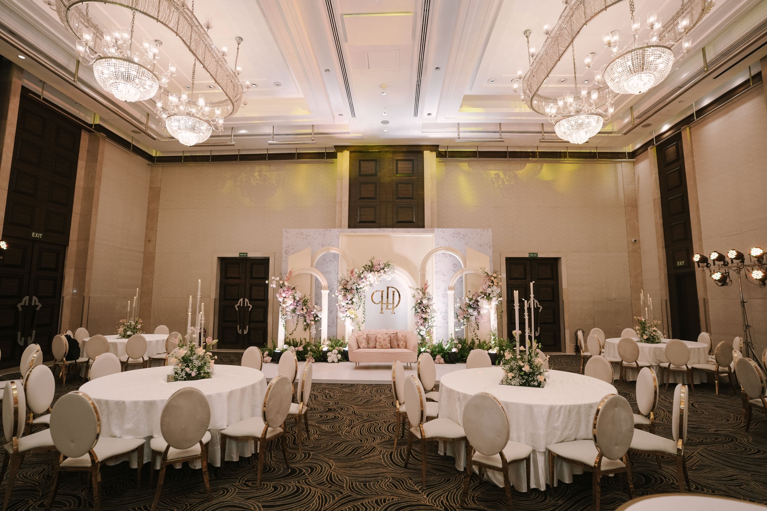 Ballroom with chandeliers and white florals at The St. Regis Mumbai
