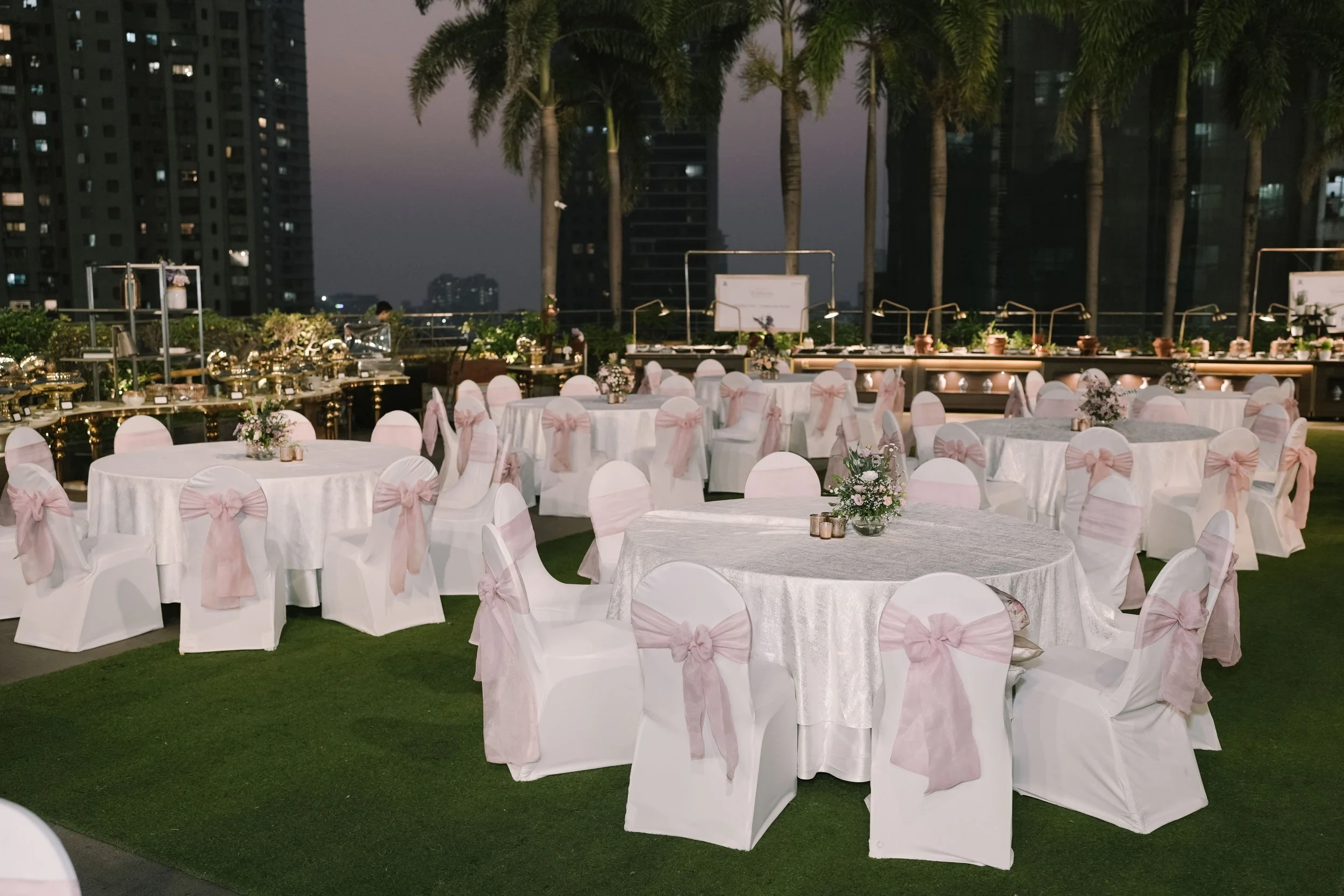 Rooftop lawn dinner with pink sashes at The St. Regis Mumbai