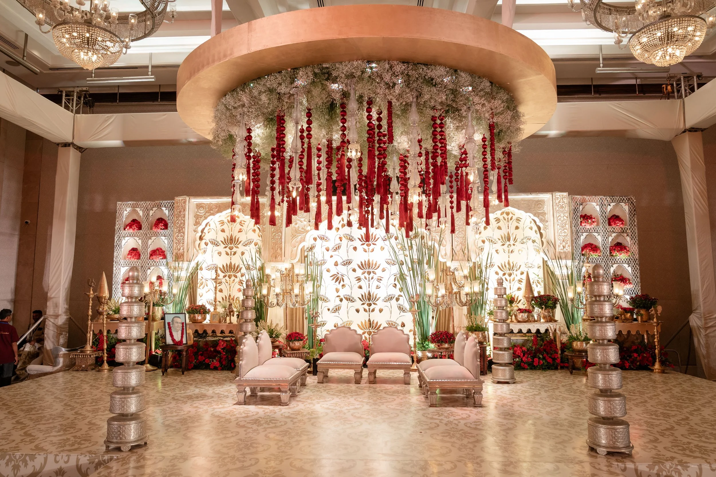 Red floral chandelier over a stage at The St. Regis Mumbai