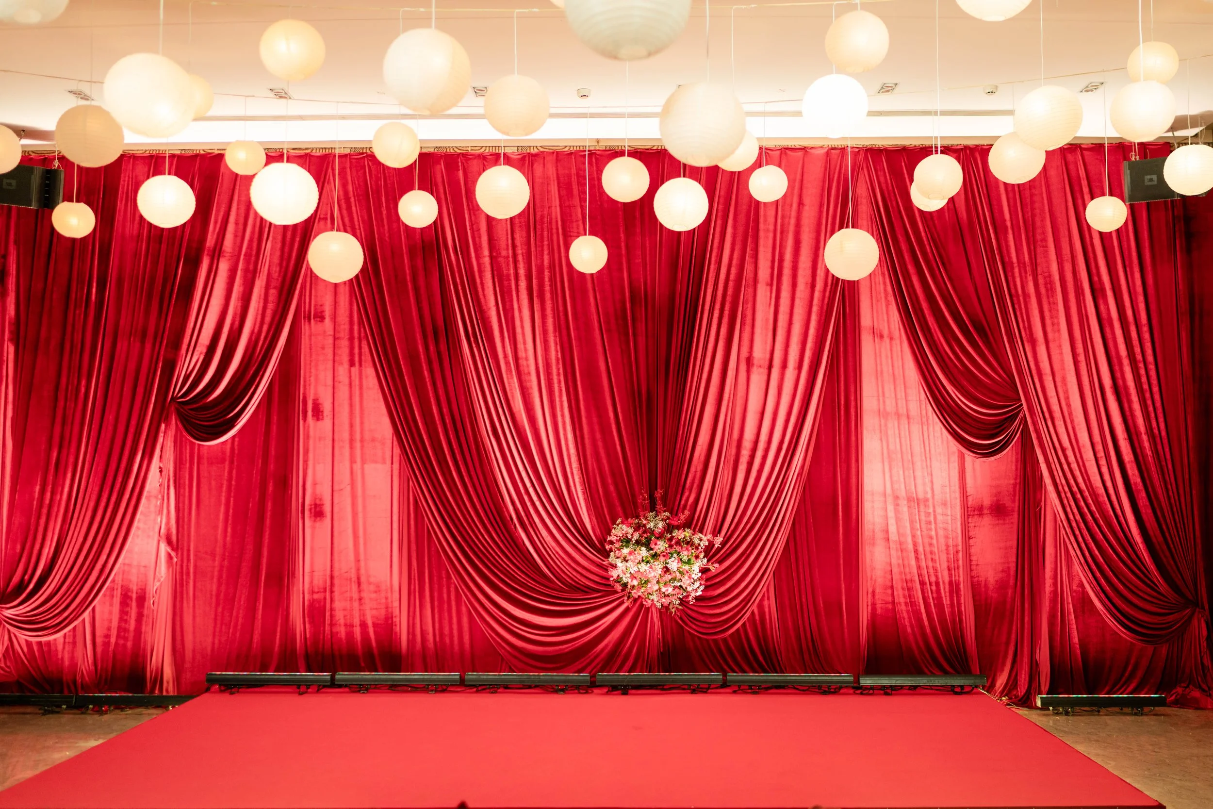Red velvet drapes and paper lanterns at Blue Sea Banquets Worli