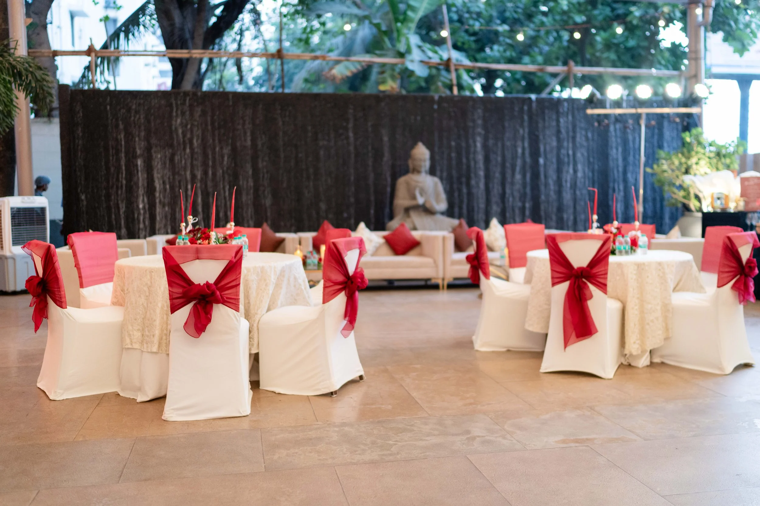Outdoor tables with red bows at Blue Sea Banquets