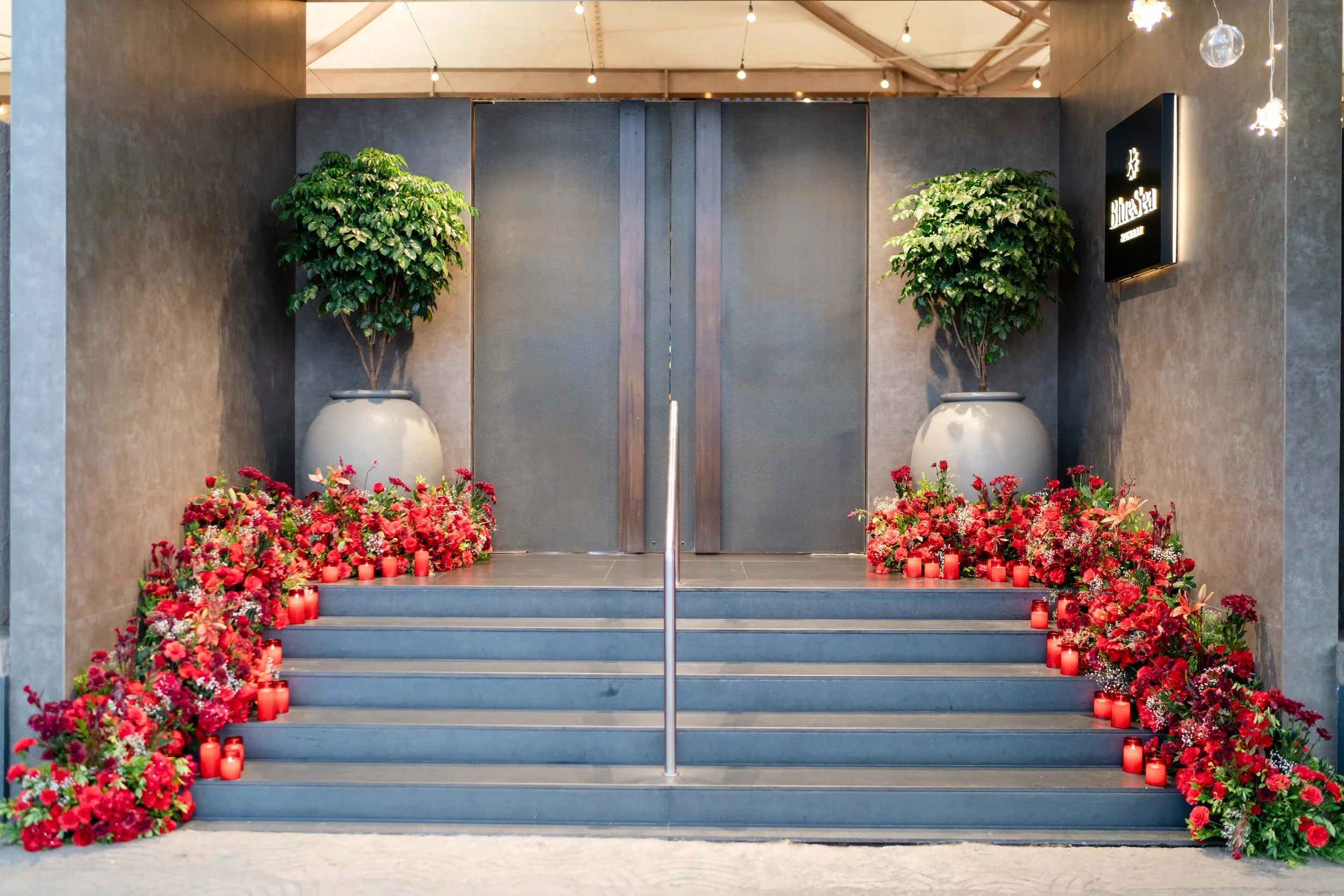 Red rose decorated entrance steps at Blue Sea Banquets