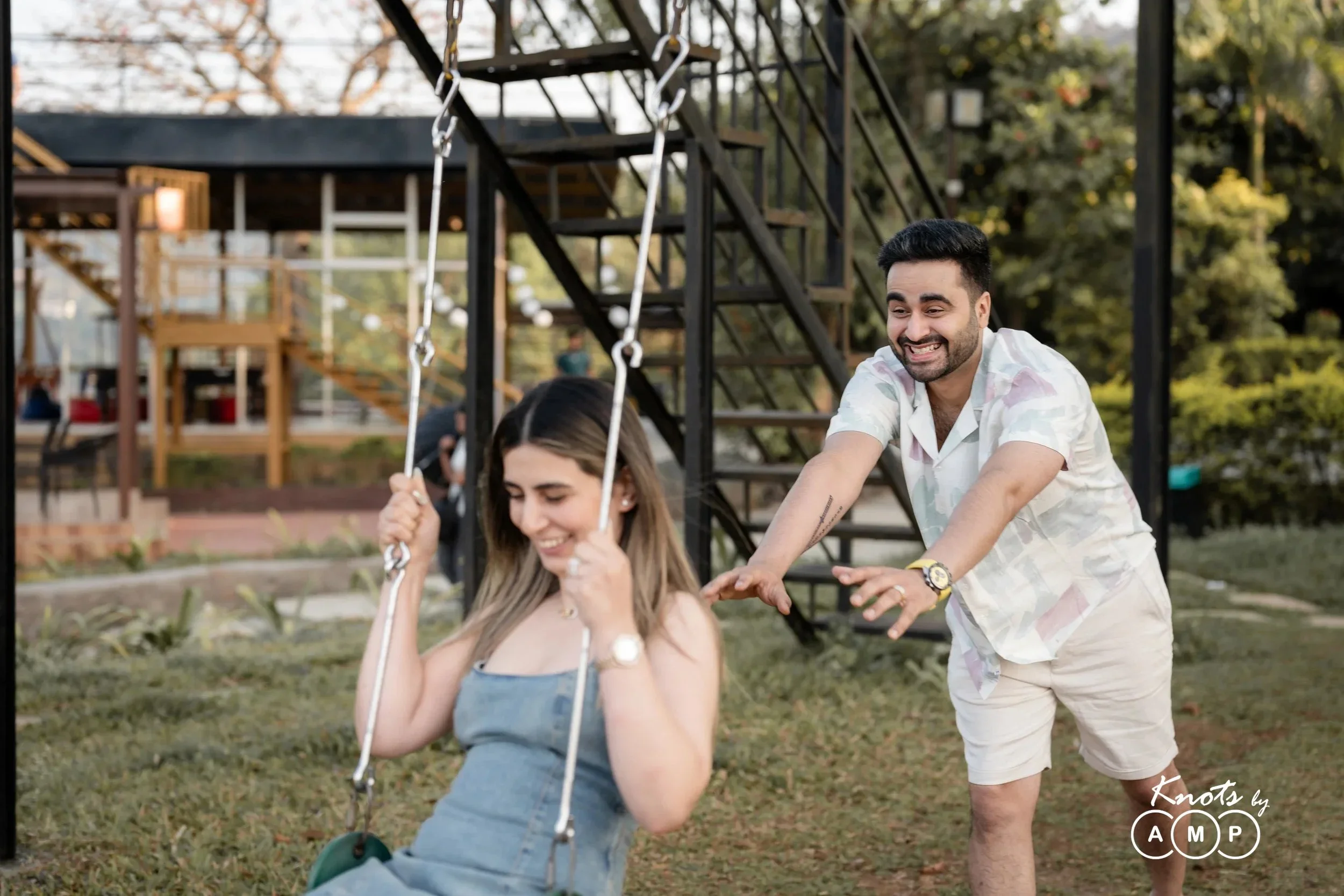Groom pushing the bride on a swing at Zostel Plus Lonavala