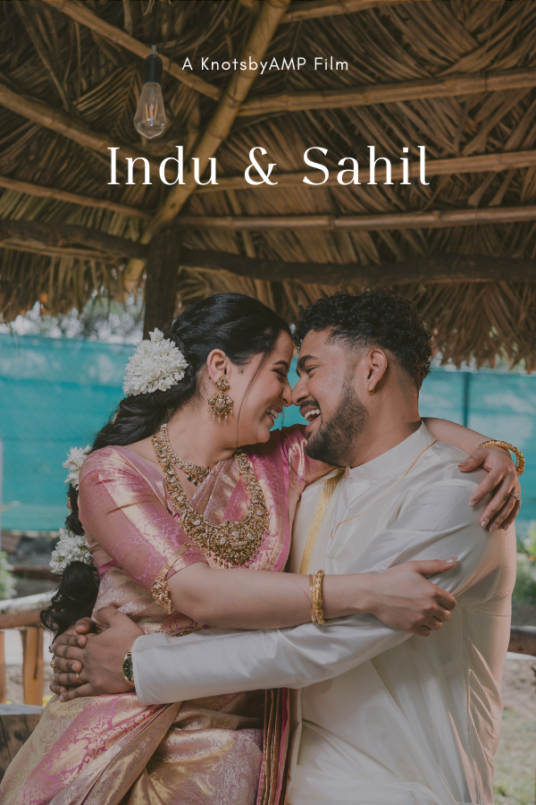 A couple dressed in traditional Indian attire sharing a happy embrace under a thatched roof, with text indicating they are part of a film titled 'Indu & Sahil'.