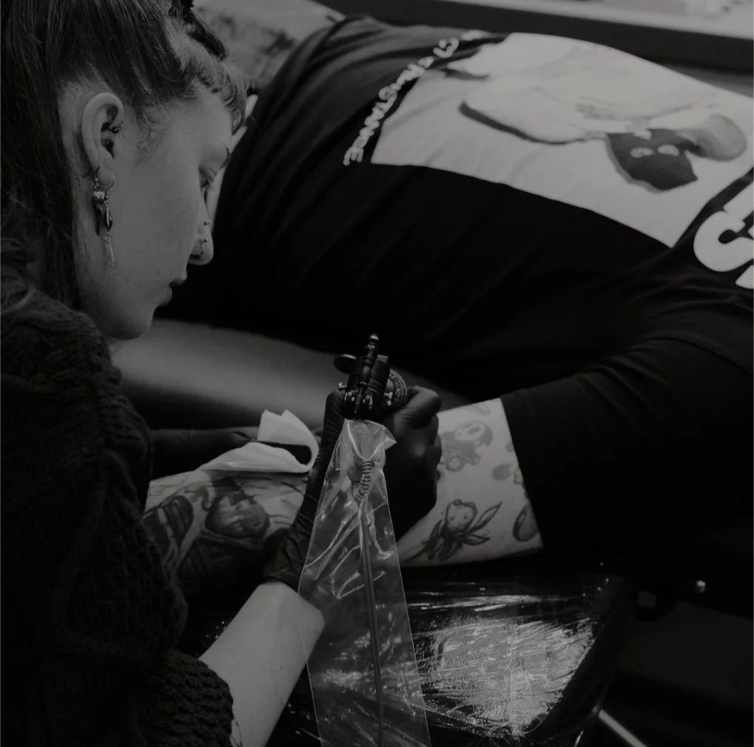 Me sat, tattooing a clients inner arm.
