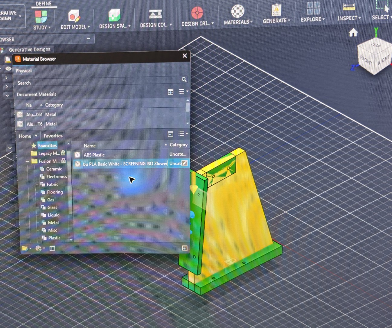 Genuine process photograph of Fusion Generative Design study geometry and the Material Browser with a PLA screening material. Privacy cropped only; not a completed optimisation result.