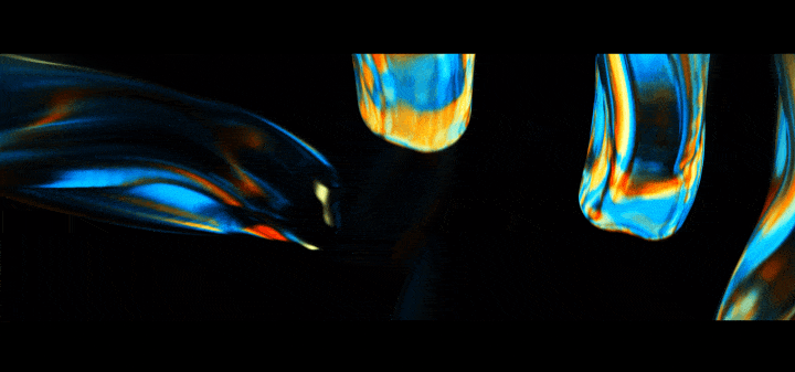 Close-up of colorful metallic glass objects with swirling blue, orange, and yellow patterns against a black background.