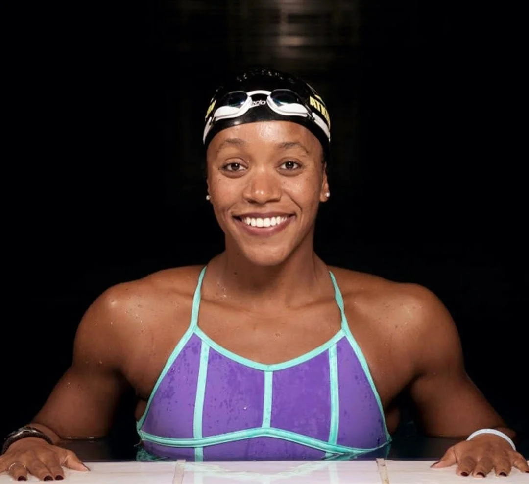 image shows alia atkinson standing in the pool smiling