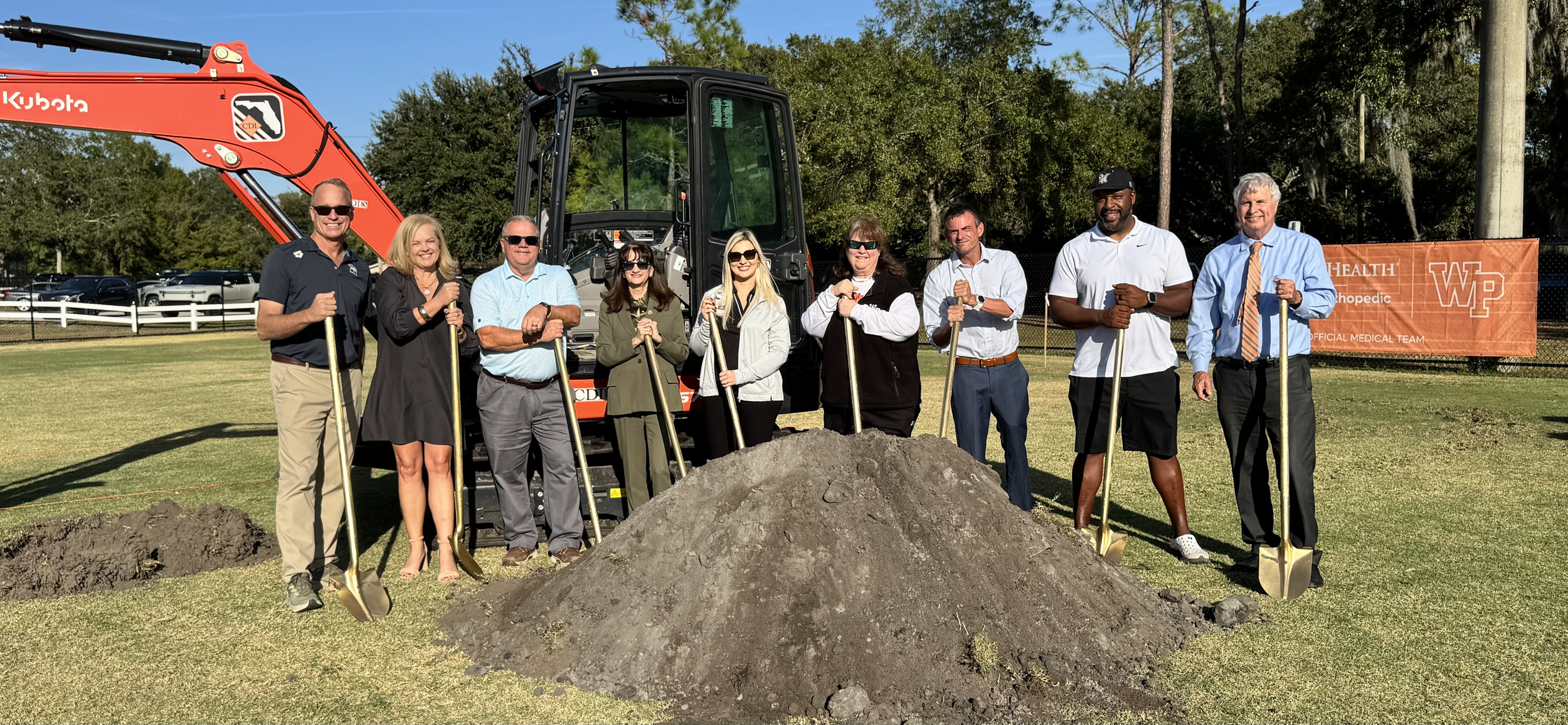 Image shows community leaders from the City of Winter Park standing with shovels at the groundbreaking of the beach volleyball courts at Cady Way