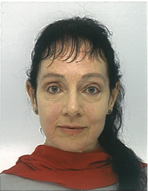 A woman with dark hair with a fringe, wearing a red scarf, against a plain background.