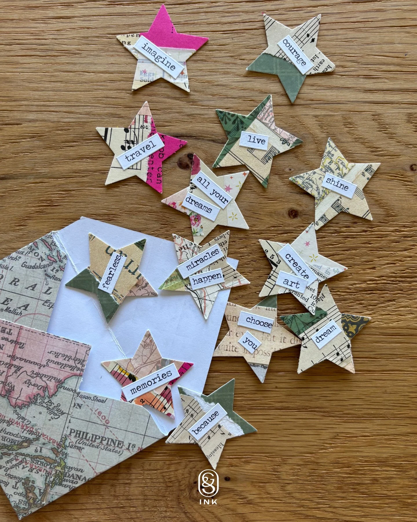 paper stars with words typed on them, including: imagine, courage, travel, live, shine,  all your dreams, create art, miracles happen, fearless, choose you, dream, memories, because.